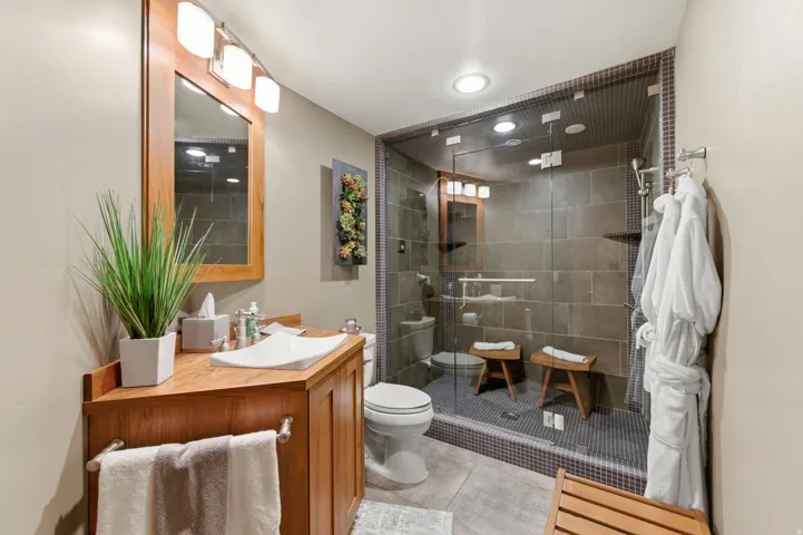 Full bath featuring vanity, a stall shower, recessed lighting, and light tile patterned floors
