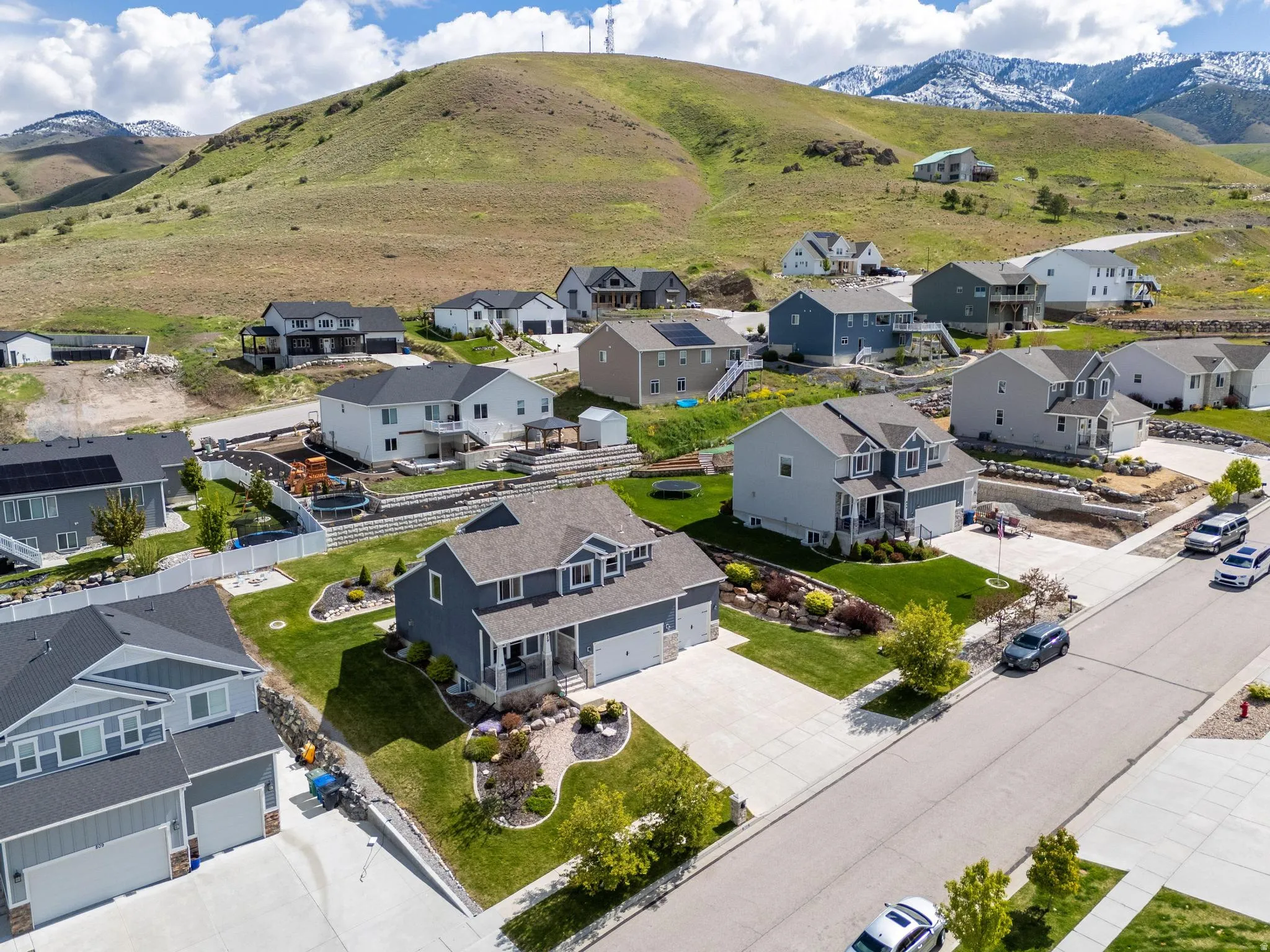 Aerial perspective of suburban area featuring a mountainous background
