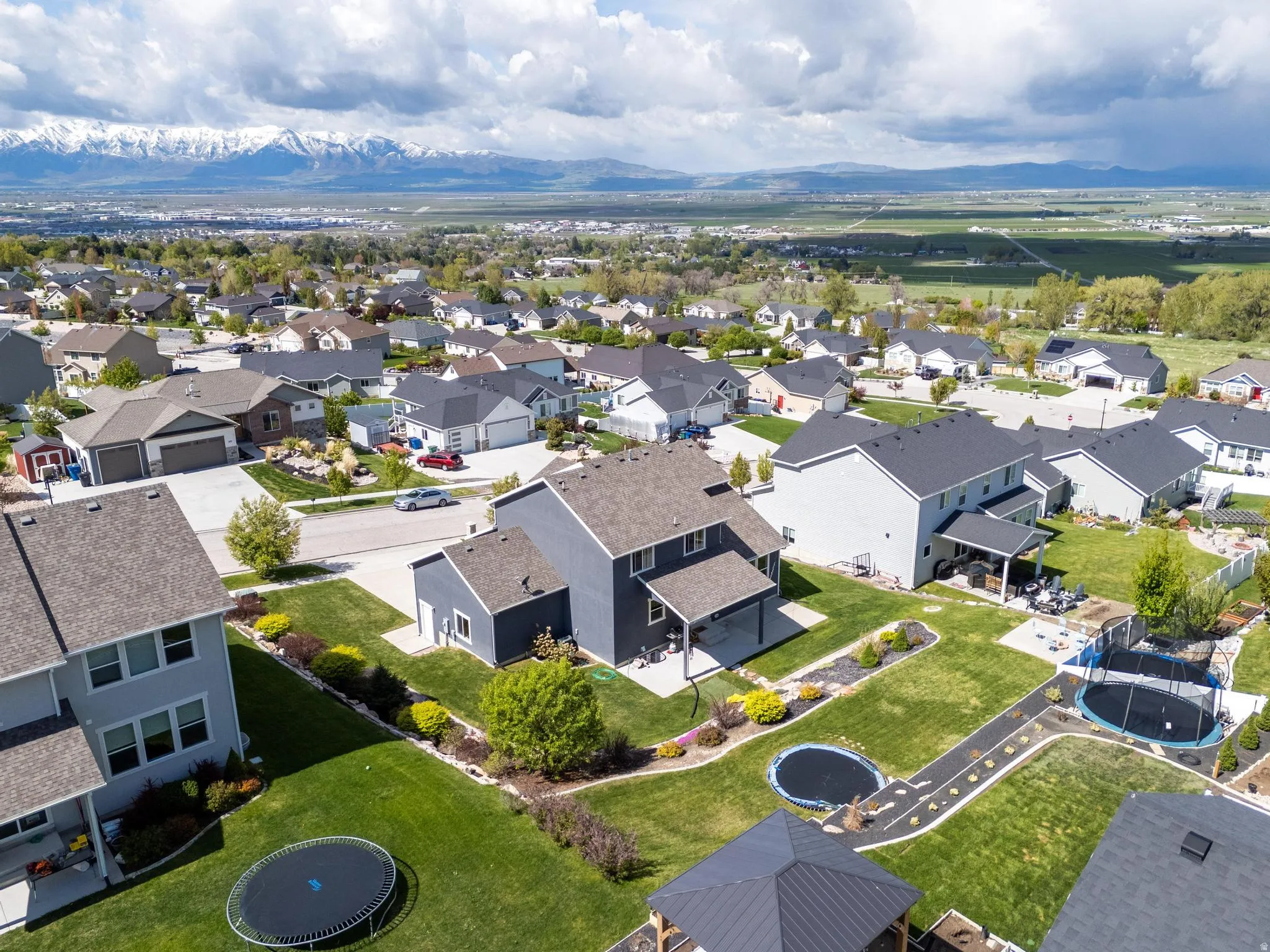 Expansive neighborhood setting with established homes, manicured lawns, and mature landscaping