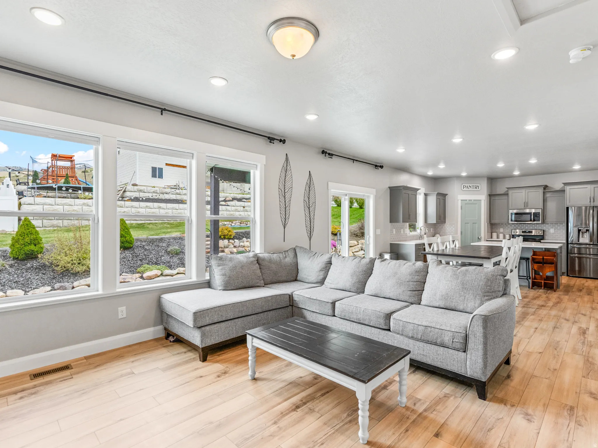 Living room featuring light wood-style floors and recessed lighting