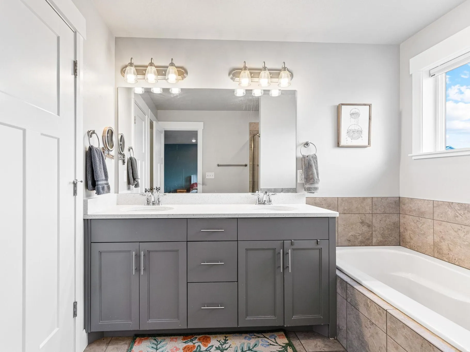 Bathroom with double vanity and a garden tub