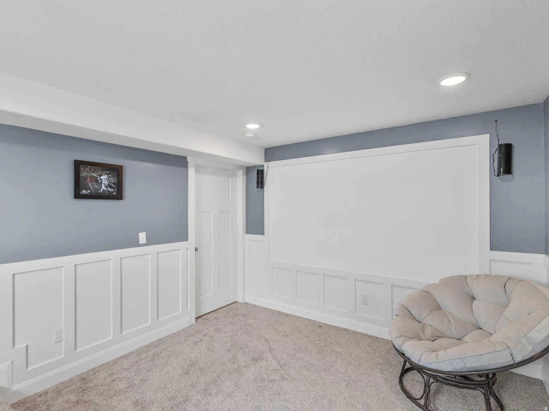 Unfurnished room with a decorative wall, wainscoting, recessed lighting, and carpet floors