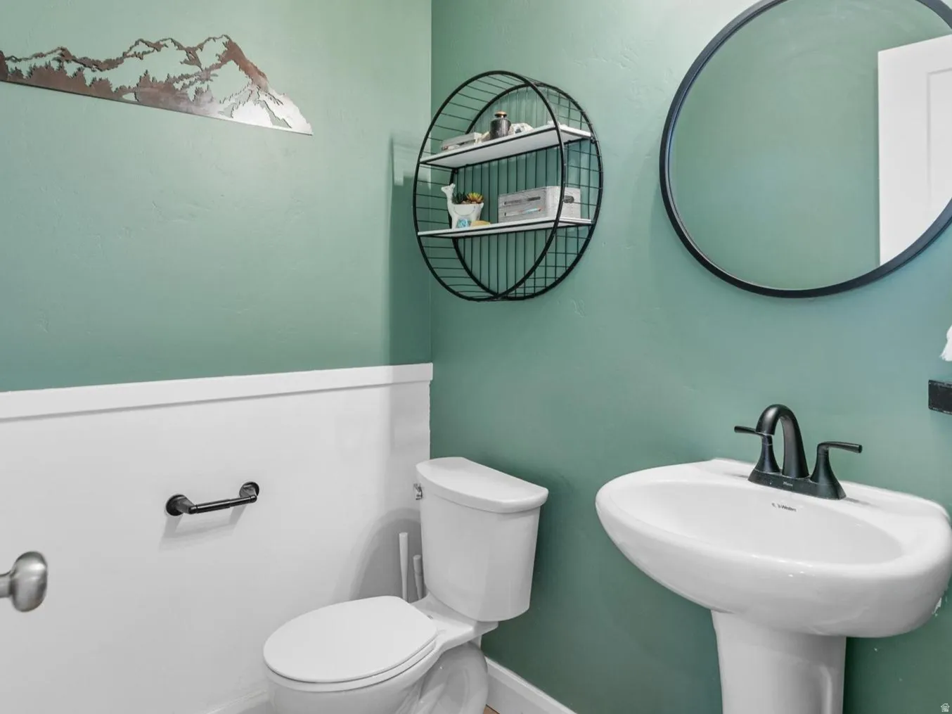 Half bathroom featuring light wood-style flooring and a textured ceiling