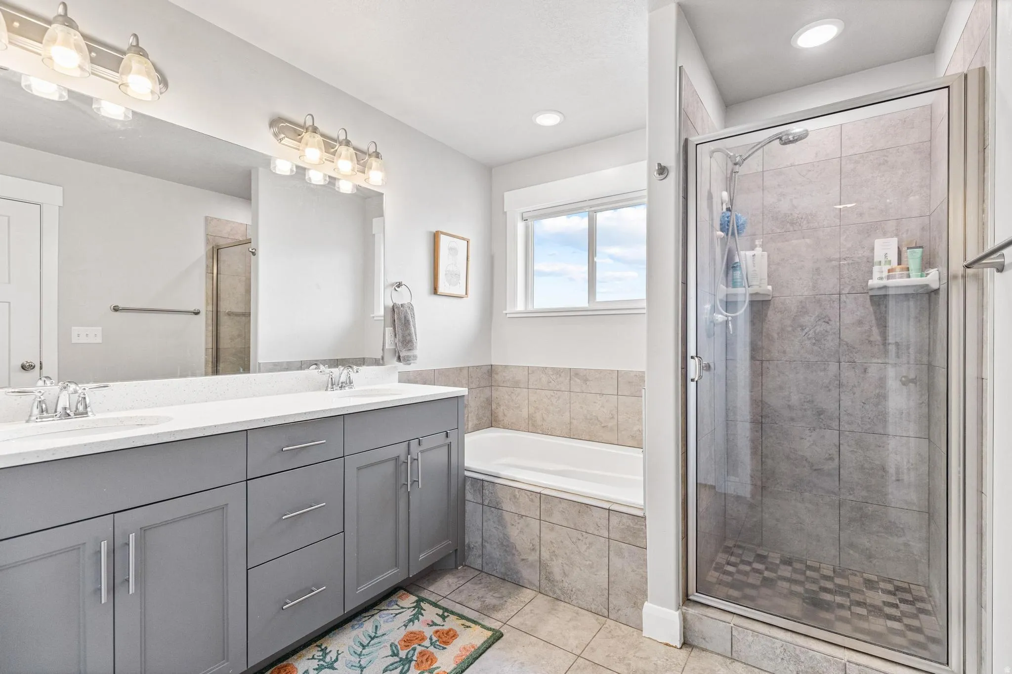 Dual vanity with gray cabinetry and white countertops