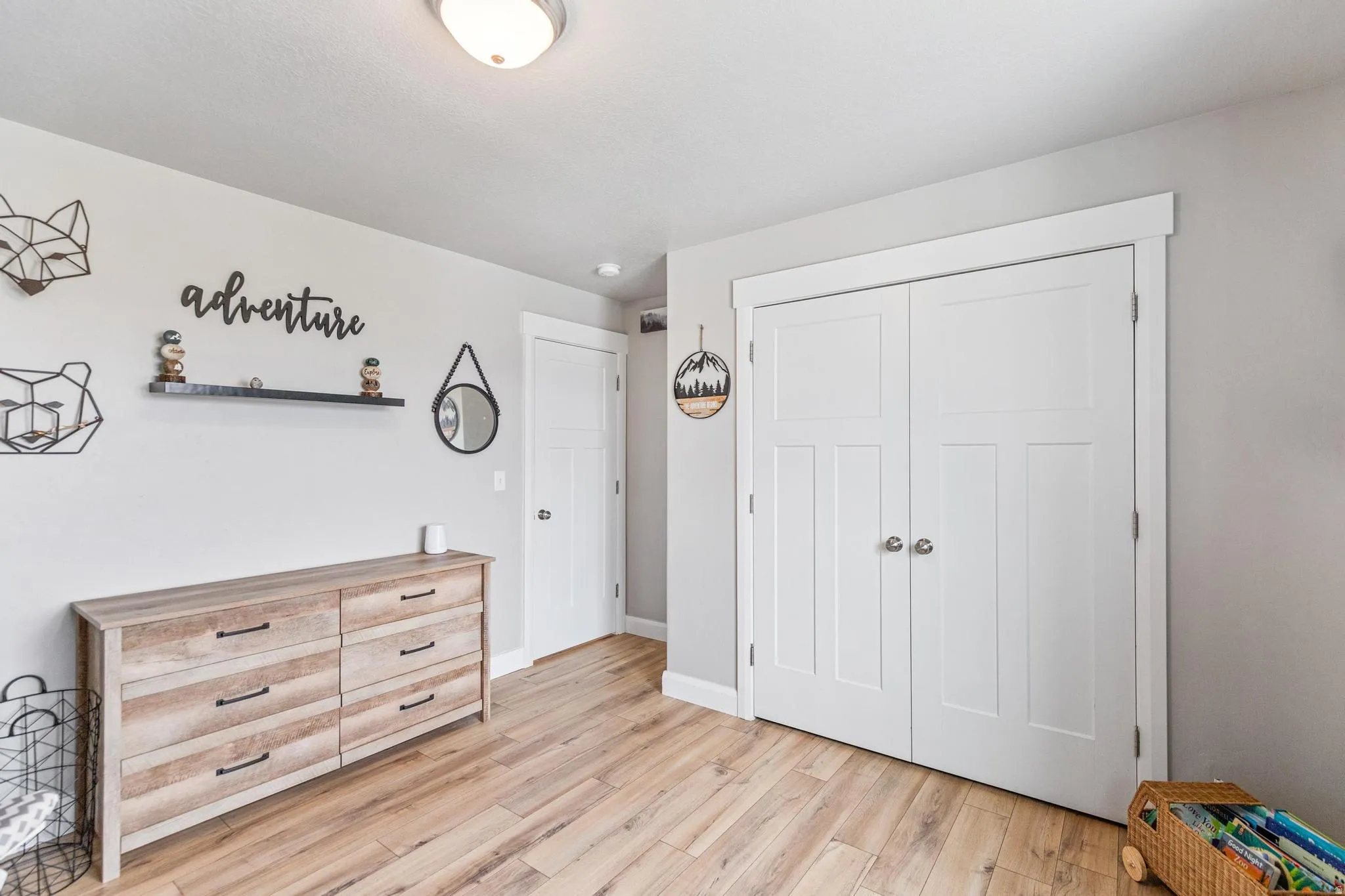 Unfurnished bedroom featuring light wood finished floors and a closet