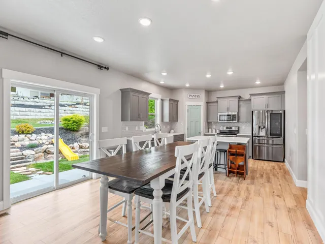 Dining area featuring light wood-style floors and recessed lighting