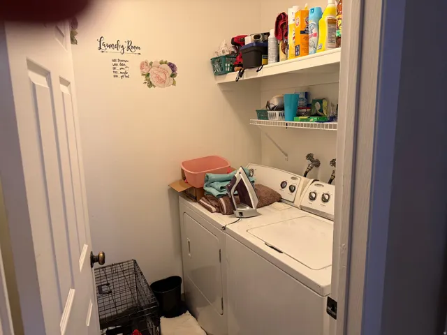 Laundry room with washing machine and clothes dryer