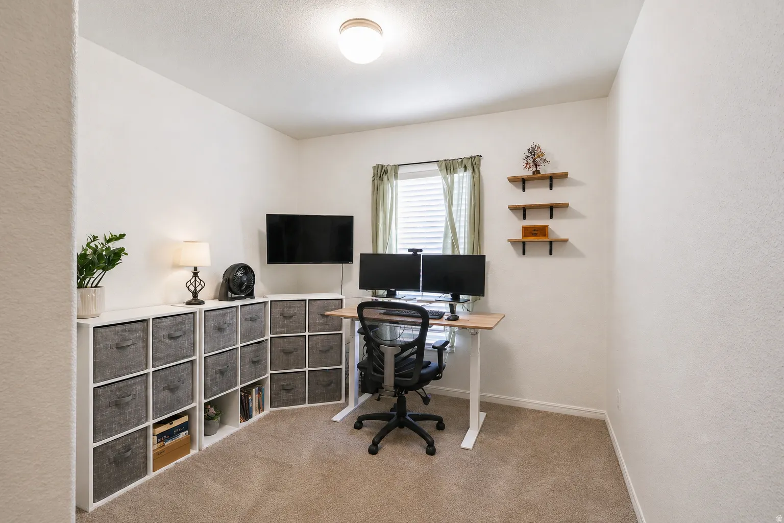 Office space with a textured wall and light carpet