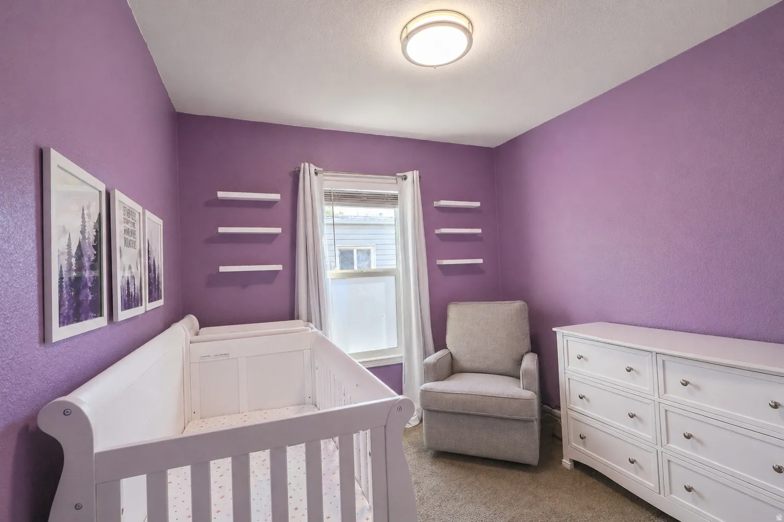 Bedroom with carpet floors and a crib