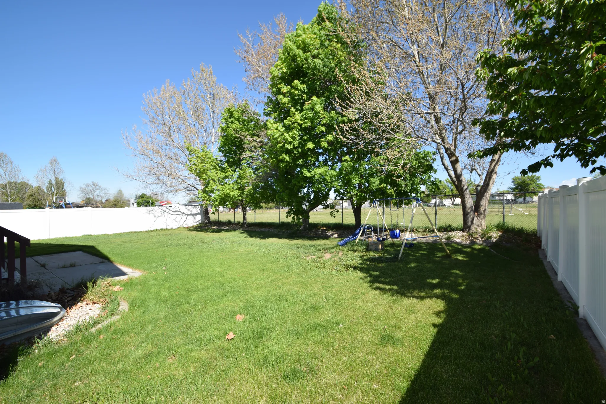 Fenced backyard with a playground