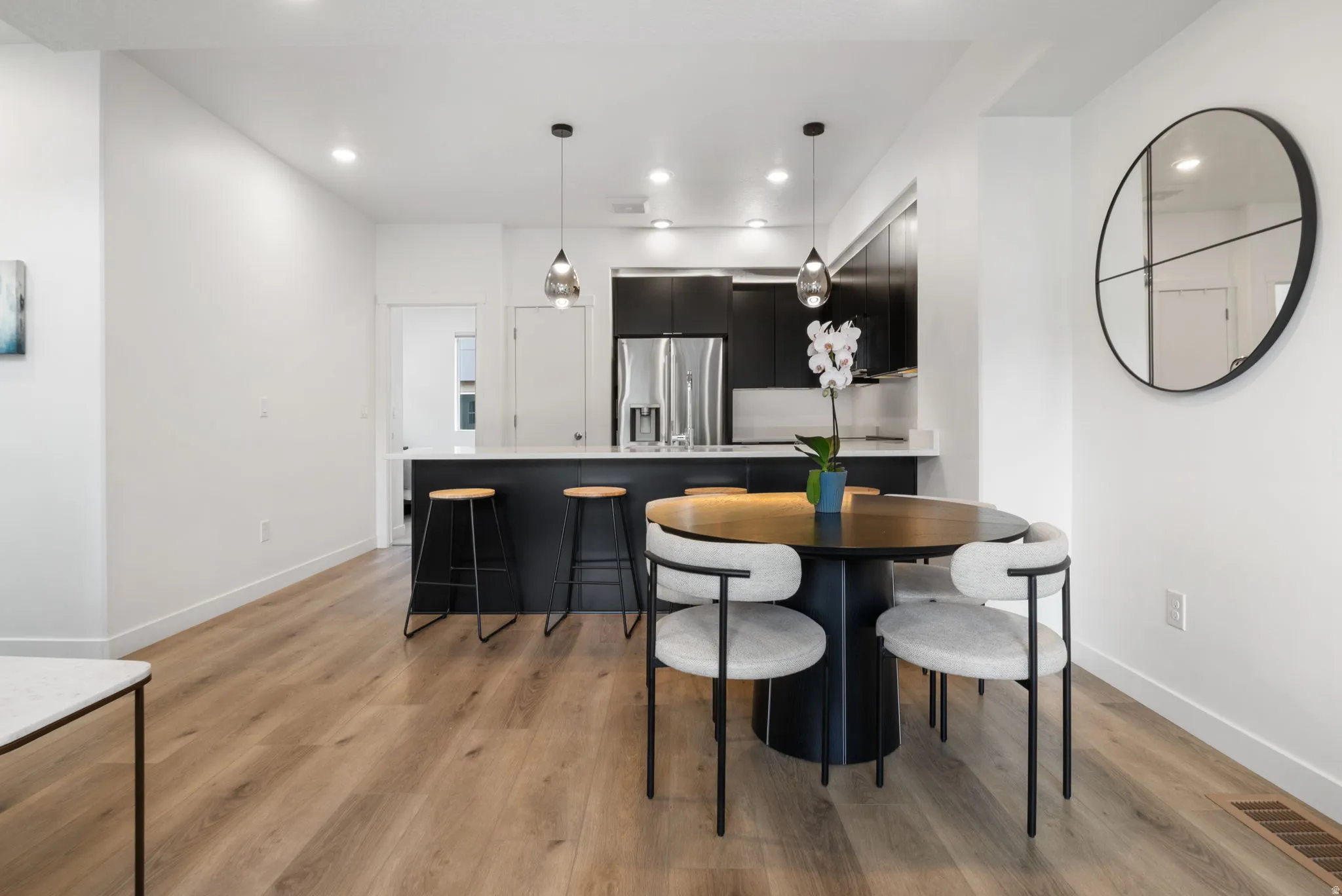 Dining room with recessed lighting and light wood-style floors