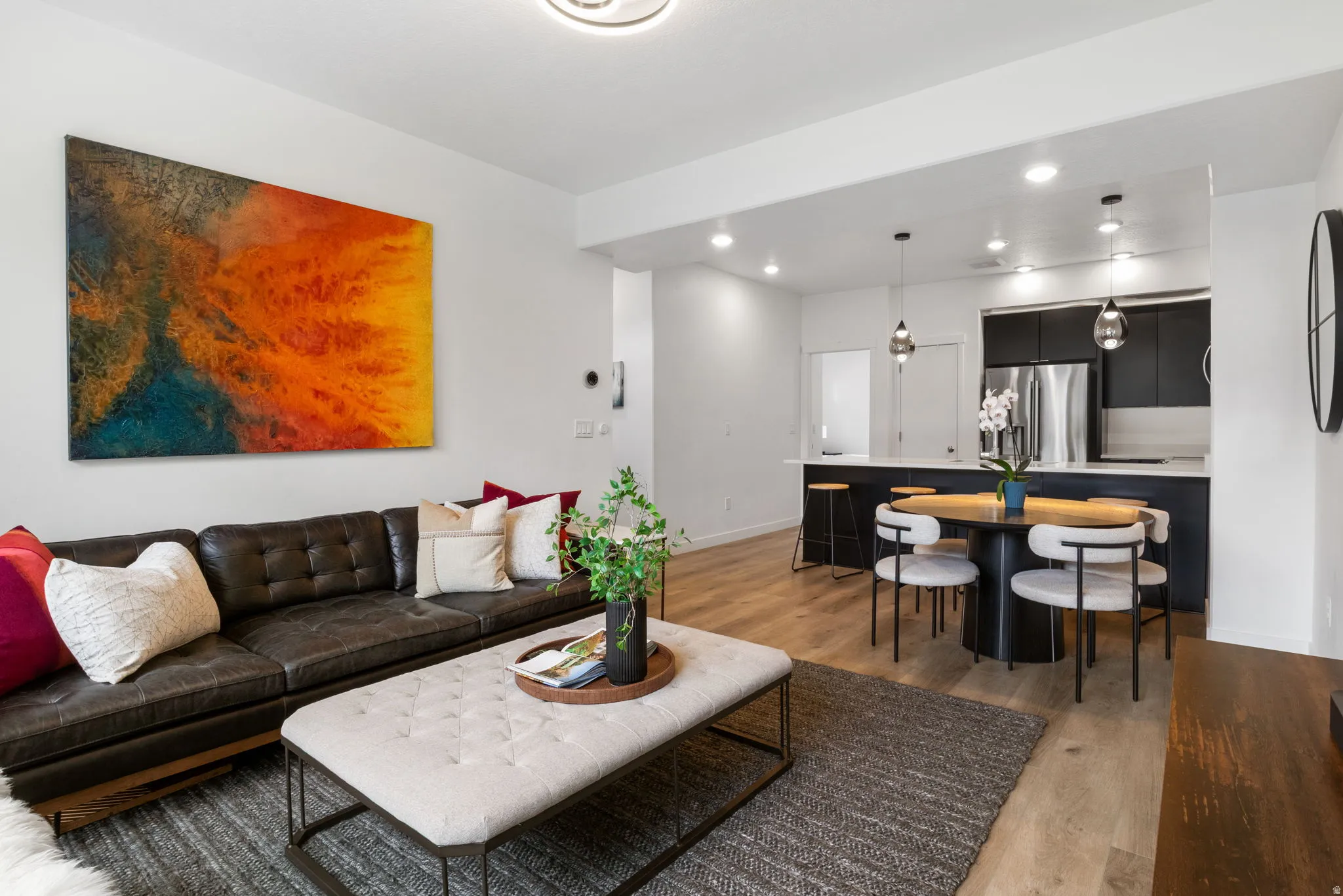 Living room with light wood finished floors and recessed lighting