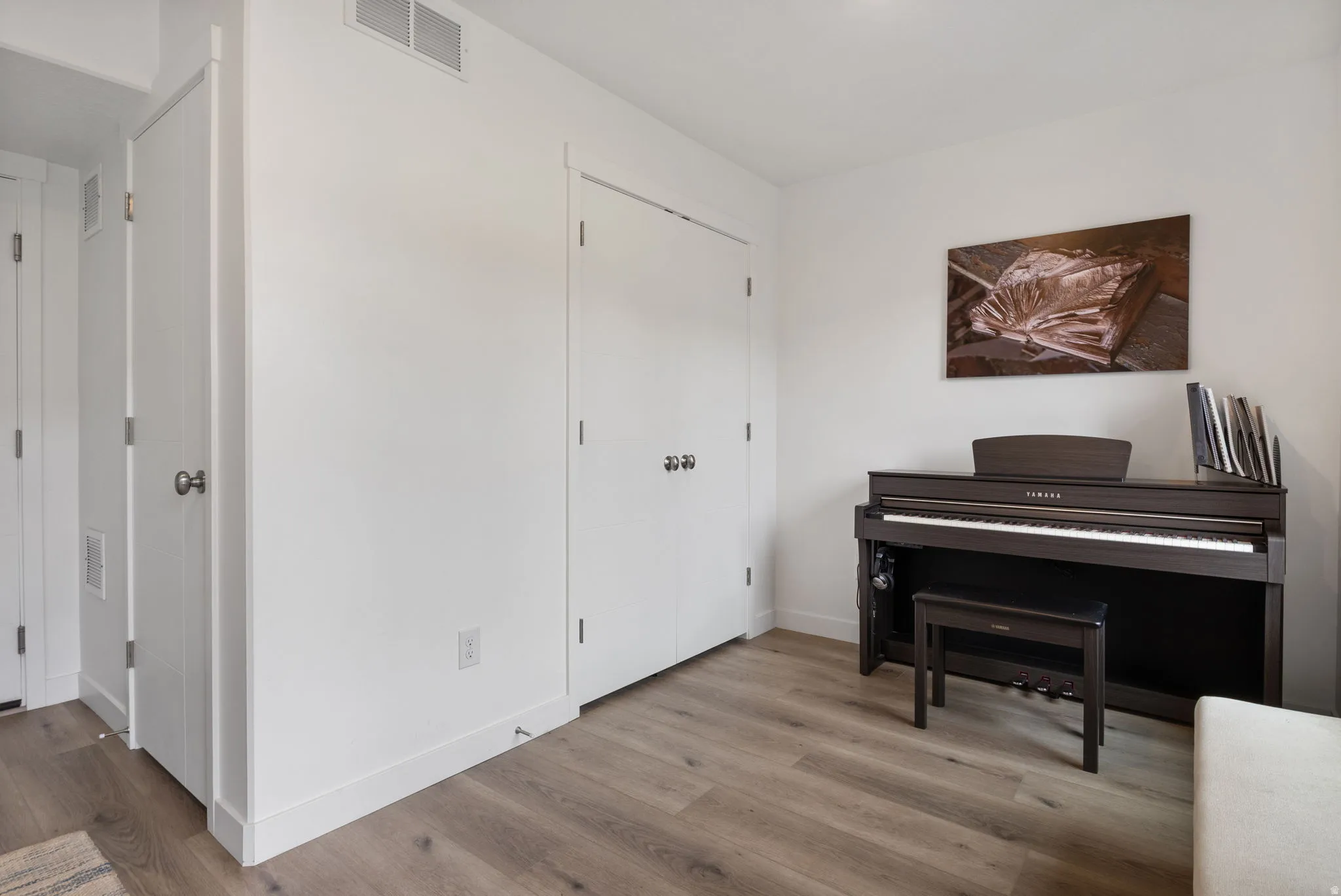 Entry/Den area featuring baseboards and light wood-type flooring