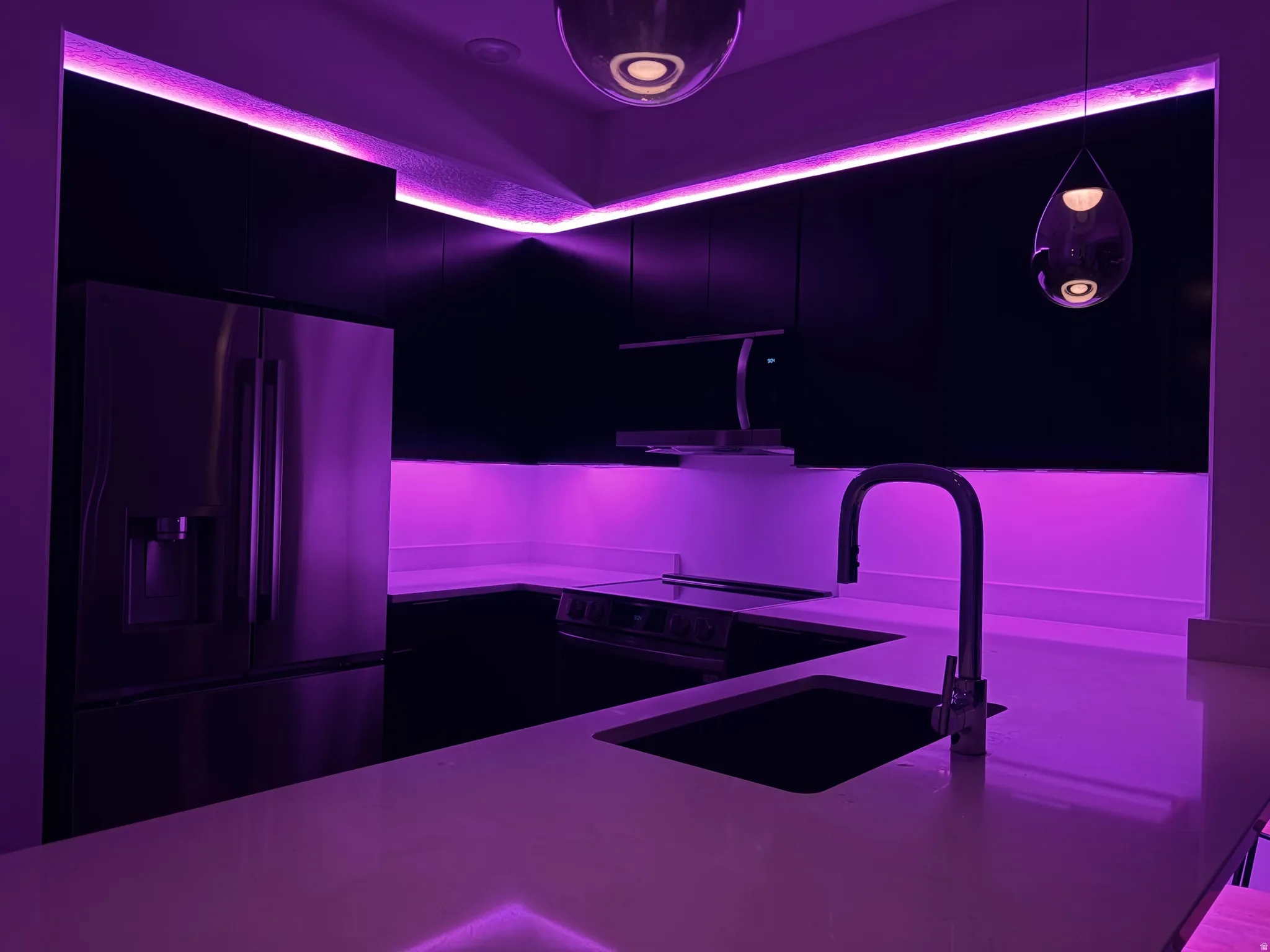 Kitchen with fridge with ice dispenser, modern cabinets, dark cabinetry, electric range, and light stone counters