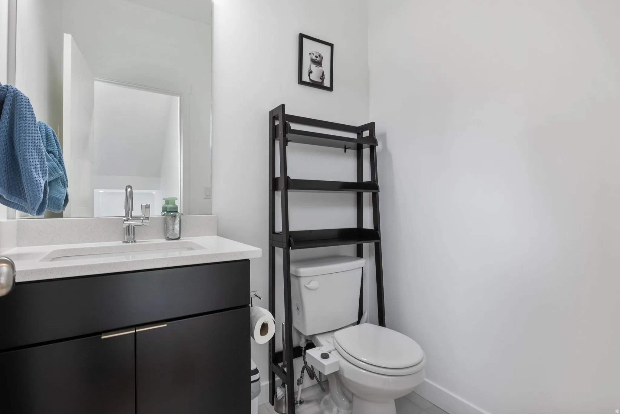 Half bath featuring toilet and vanity