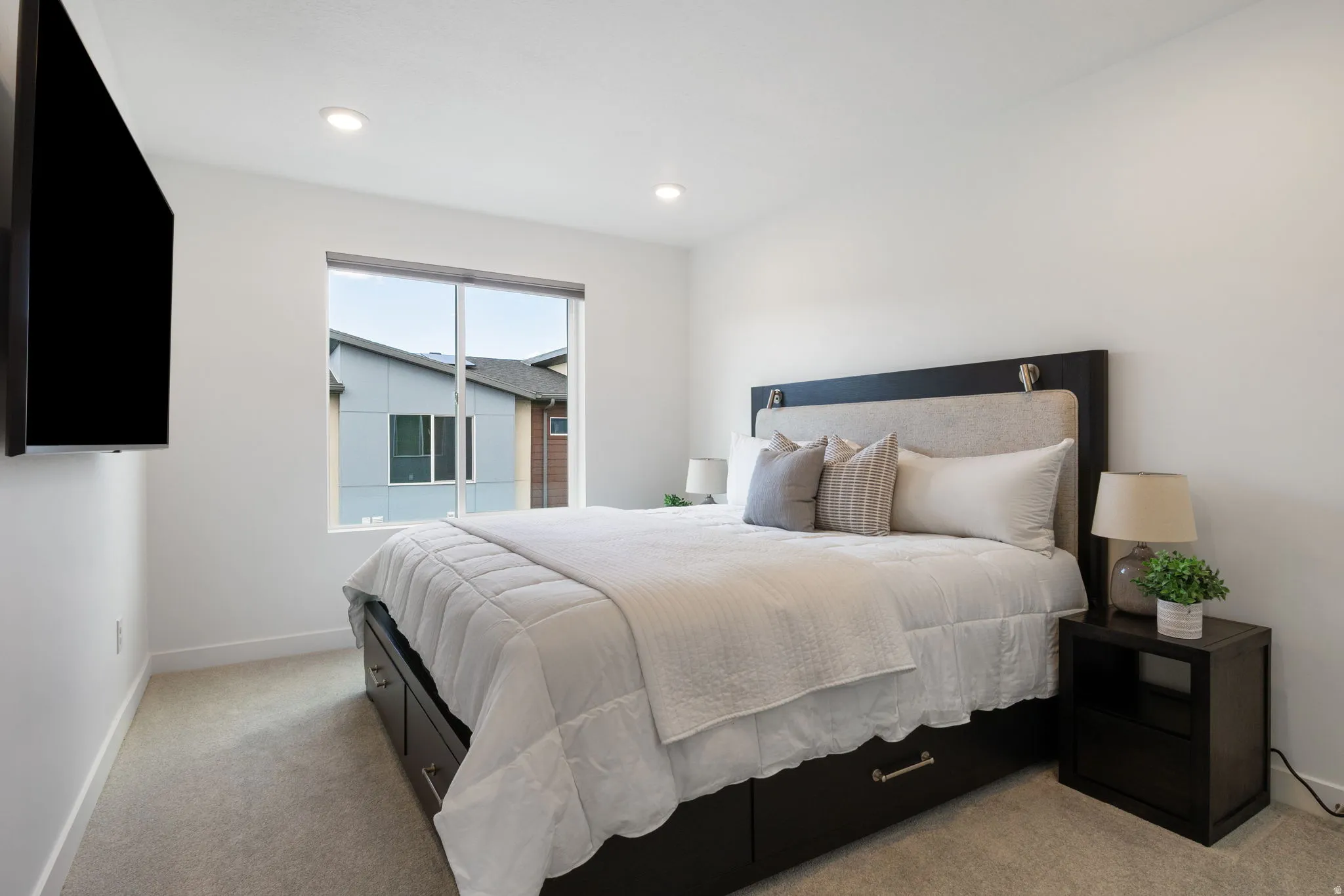 Bedroom featuring light carpet