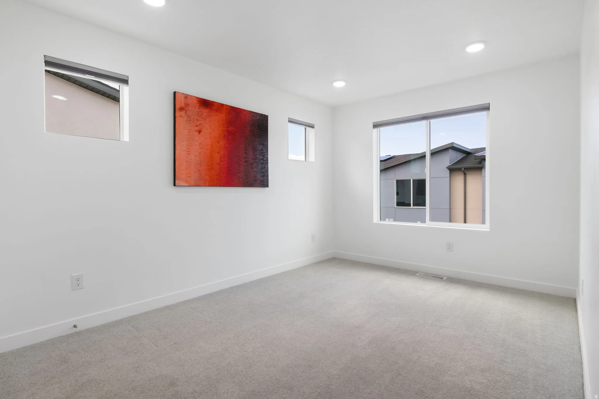 Carpeted spare room featuring baseboards and recessed lighting