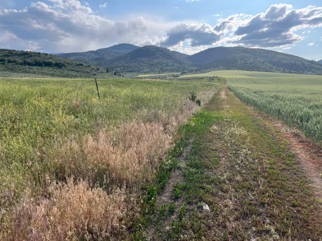 View of mountain backdrop with rural landscape