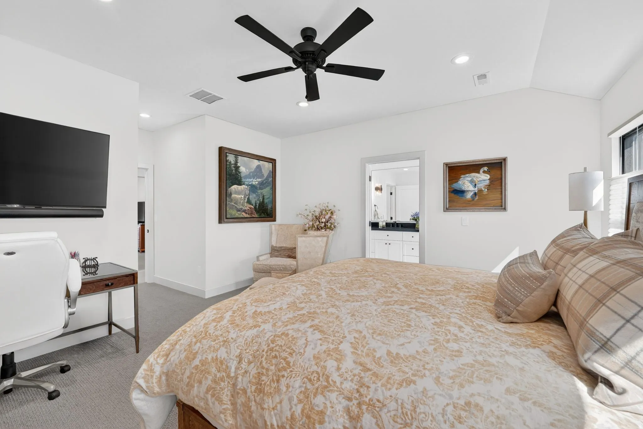 Bedroom featuring recessed lighting, a ceiling fan, light carpet, lofted ceiling, and ensuite bath