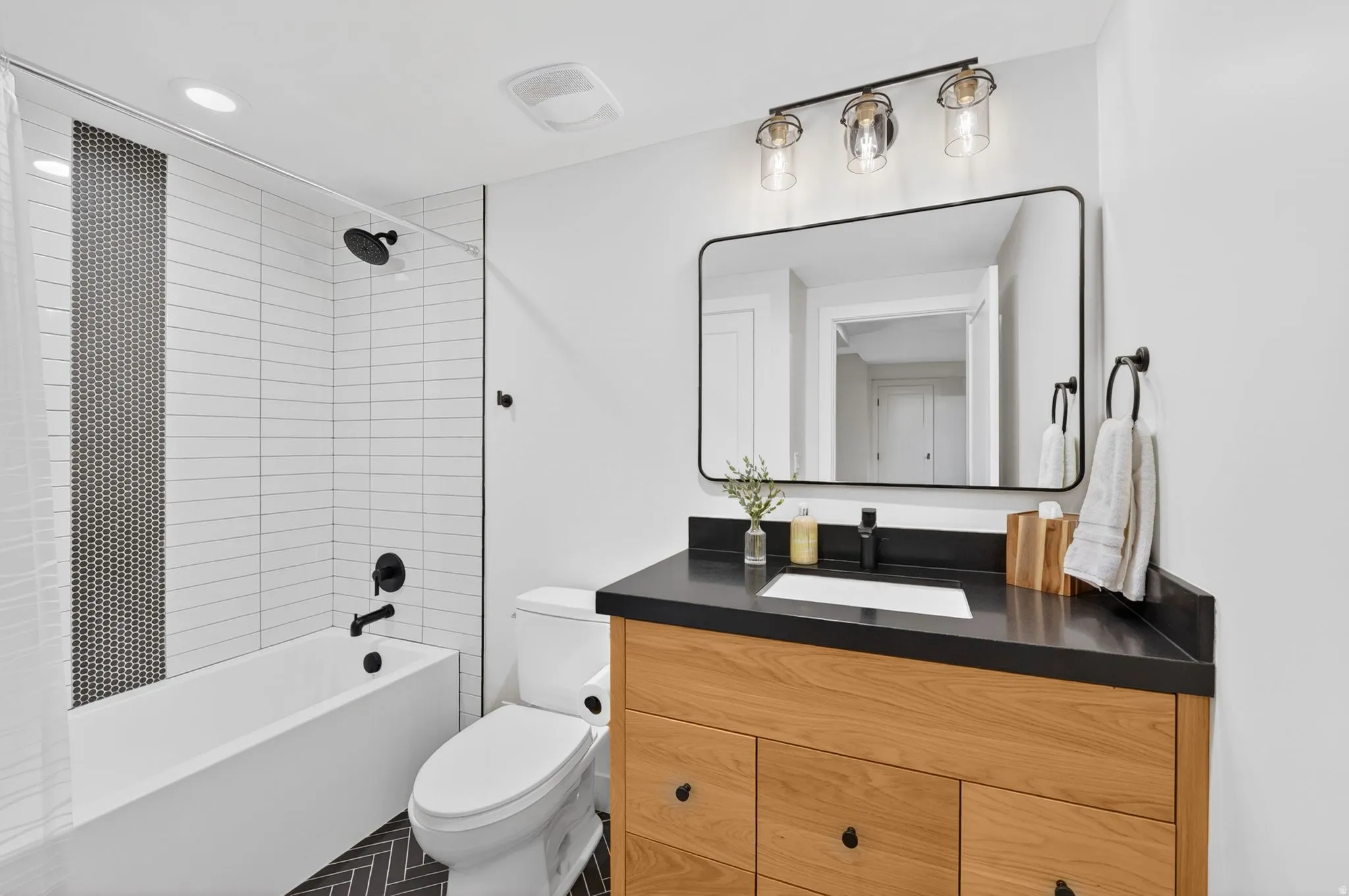 Bathroom featuring vanity,  shower combination, and recessed lighting