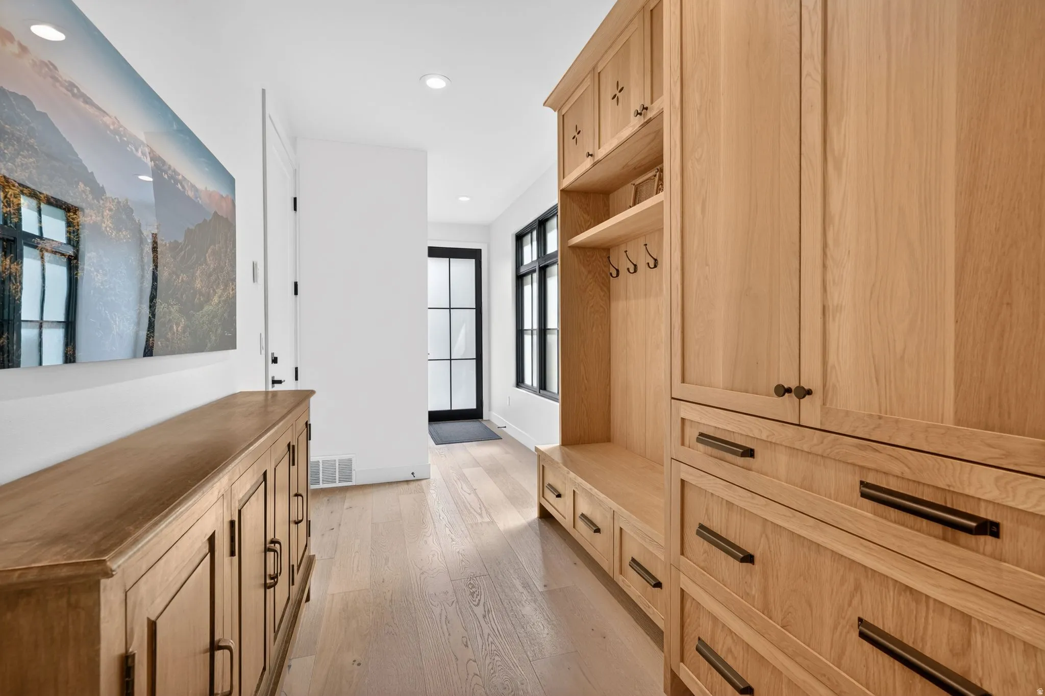 Mudroom featuring light wood-type flooring and recessed lighting