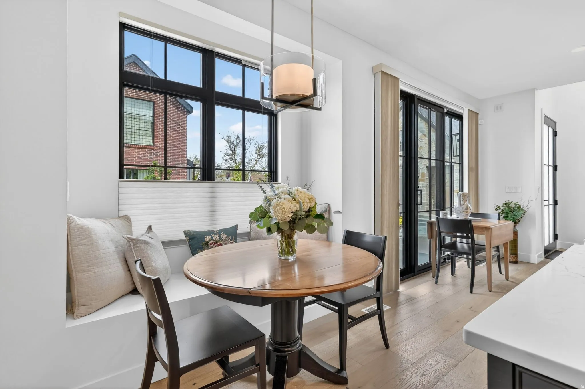 Dining area with light wood-style floors and plenty of natural light