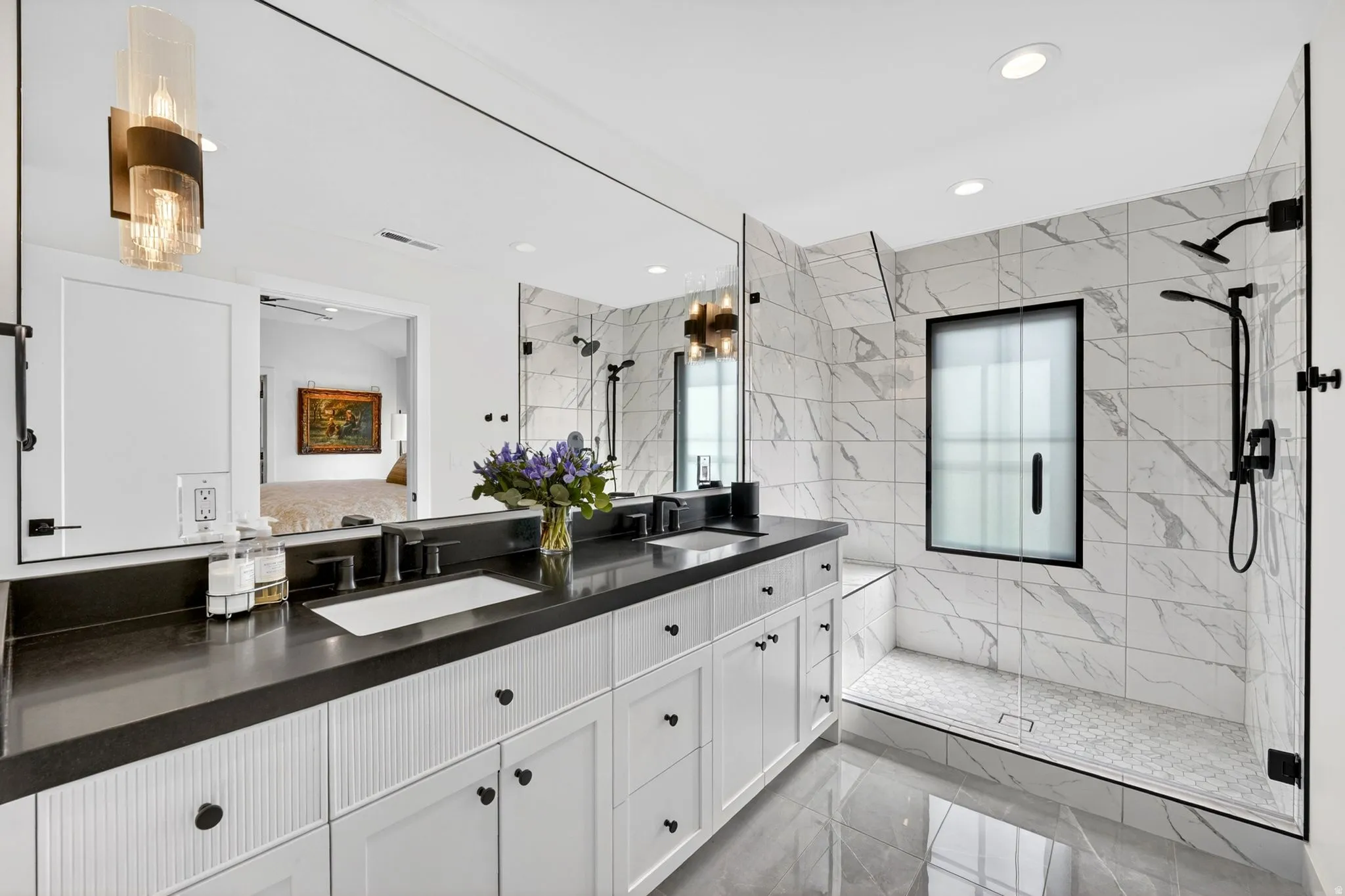 Ensuite bathroom with a marble finish shower, double vanity, recessed lighting, and light marble finish floors