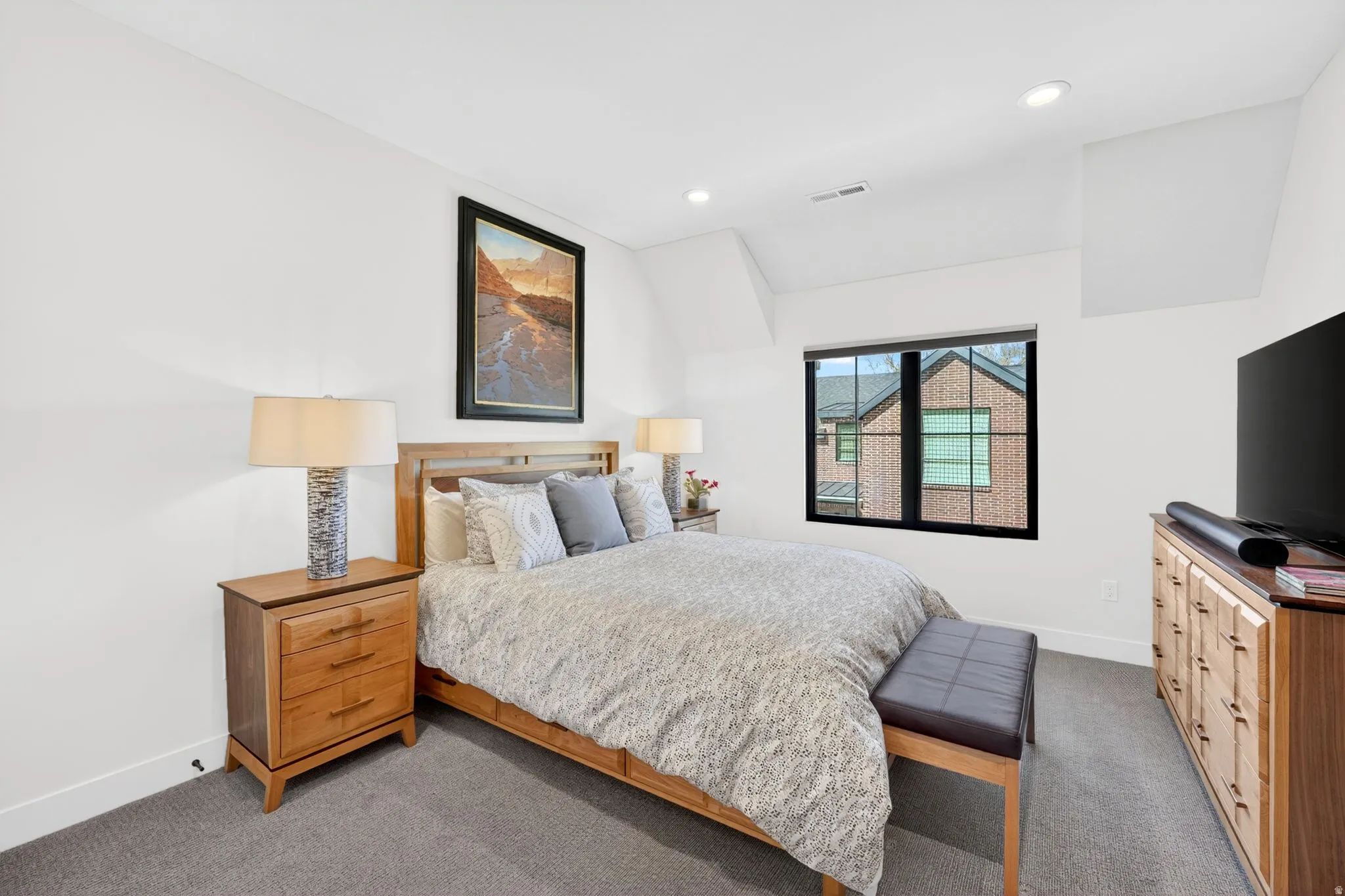 Carpeted bedroom featuring lofted ceiling and recessed lighting