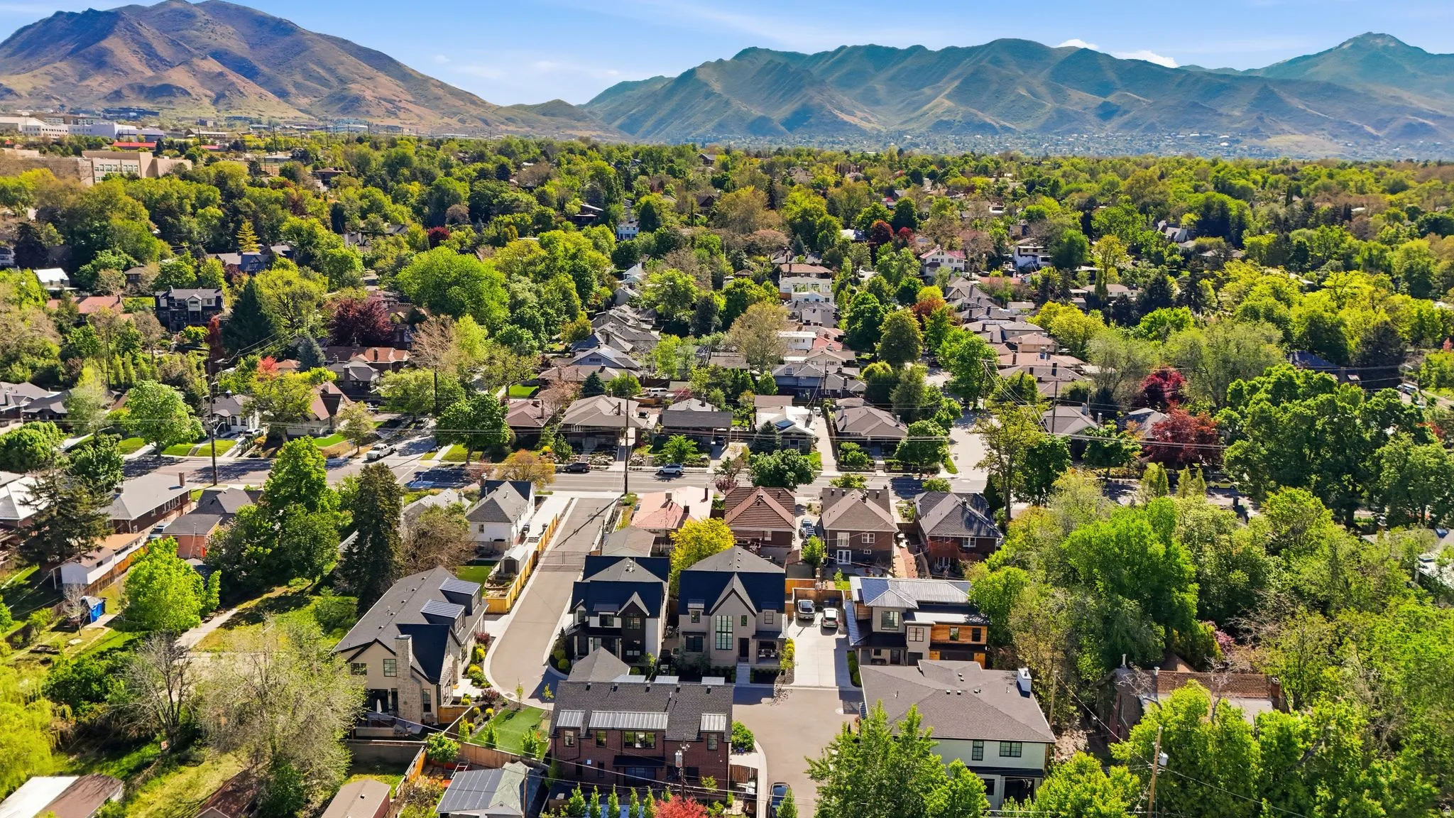Aerial perspective of suburban area featuring a mountainous background