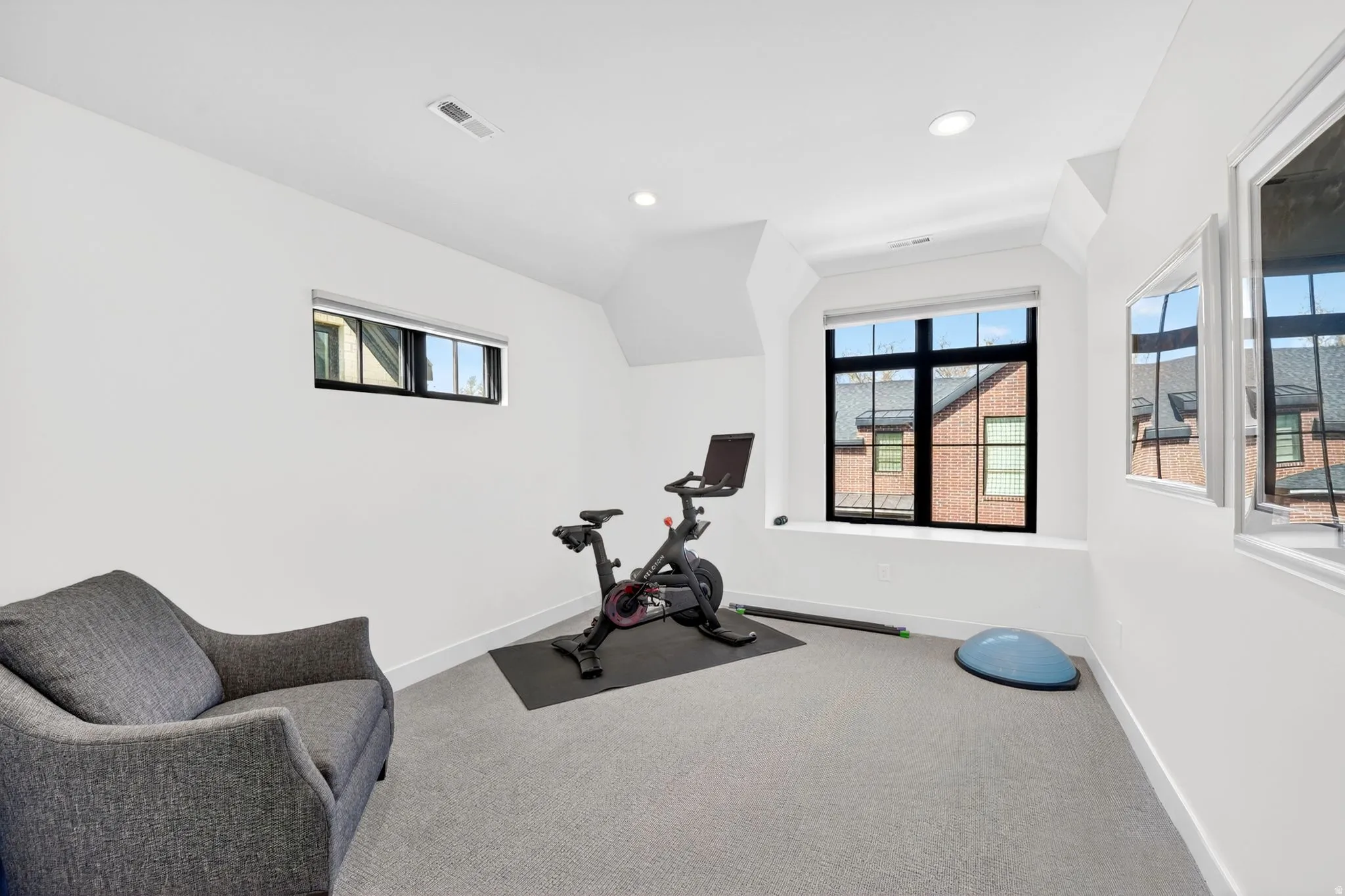 Bedroom or workout room with vaulted ceiling, carpet, and recessed lighting