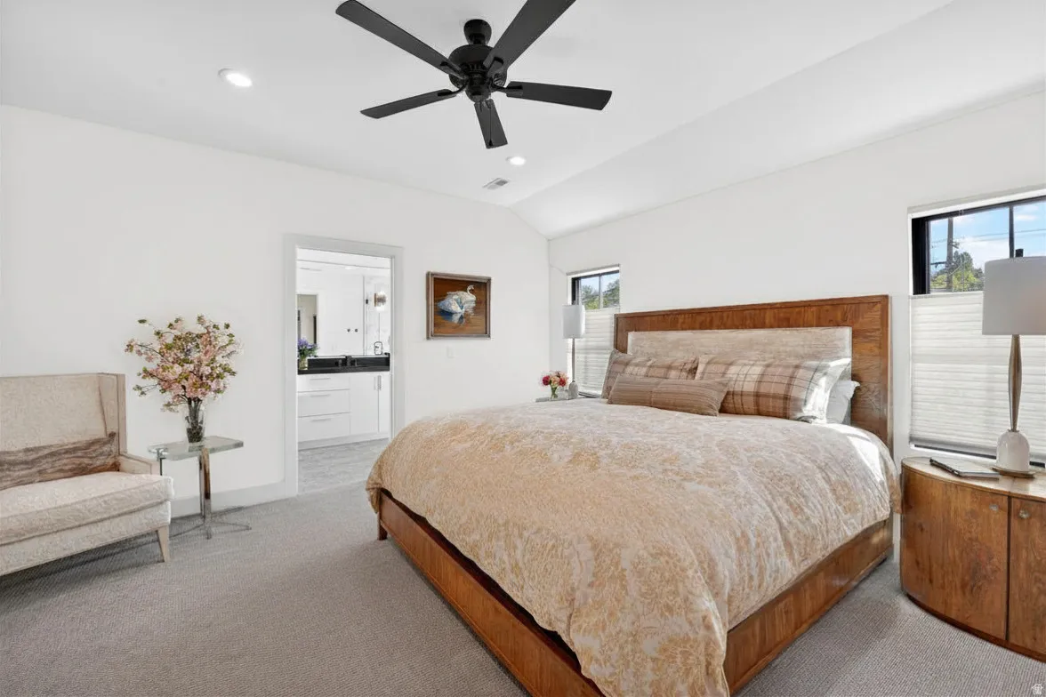 Bedroom with lofted ceiling, recessed lighting, carpet flooring, ceiling fan, and ensuite bath