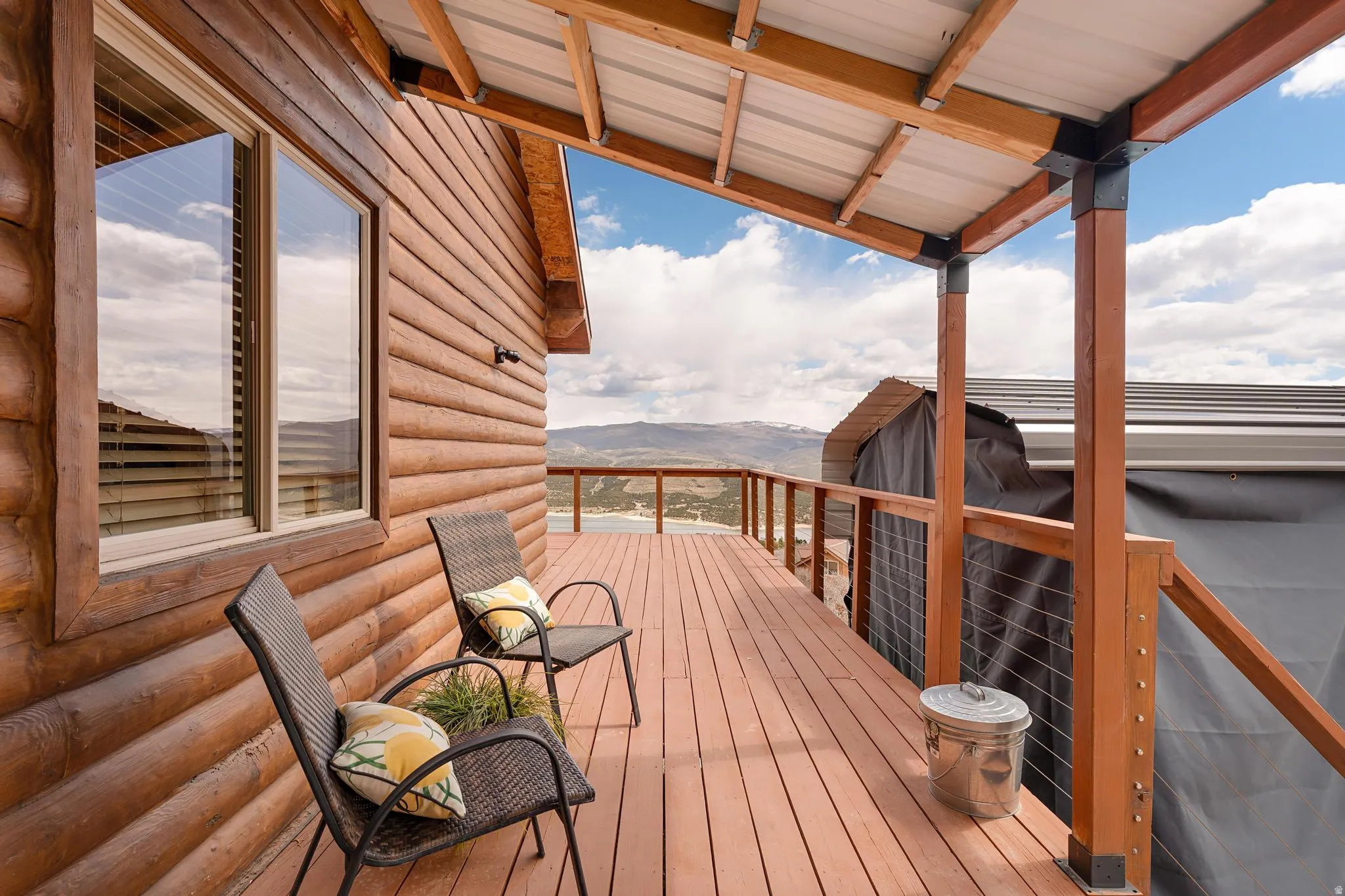 Wooden deck featuring a mountain view and grilling area