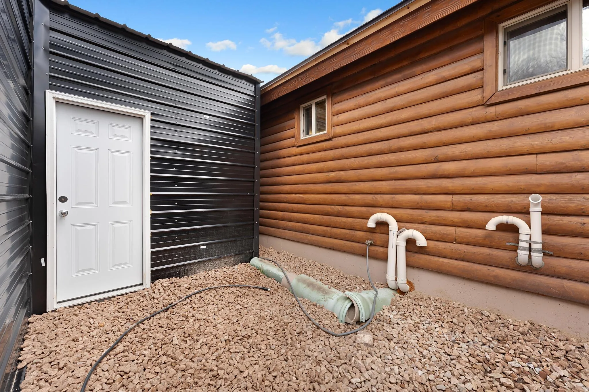 View of side of property with faux log siding