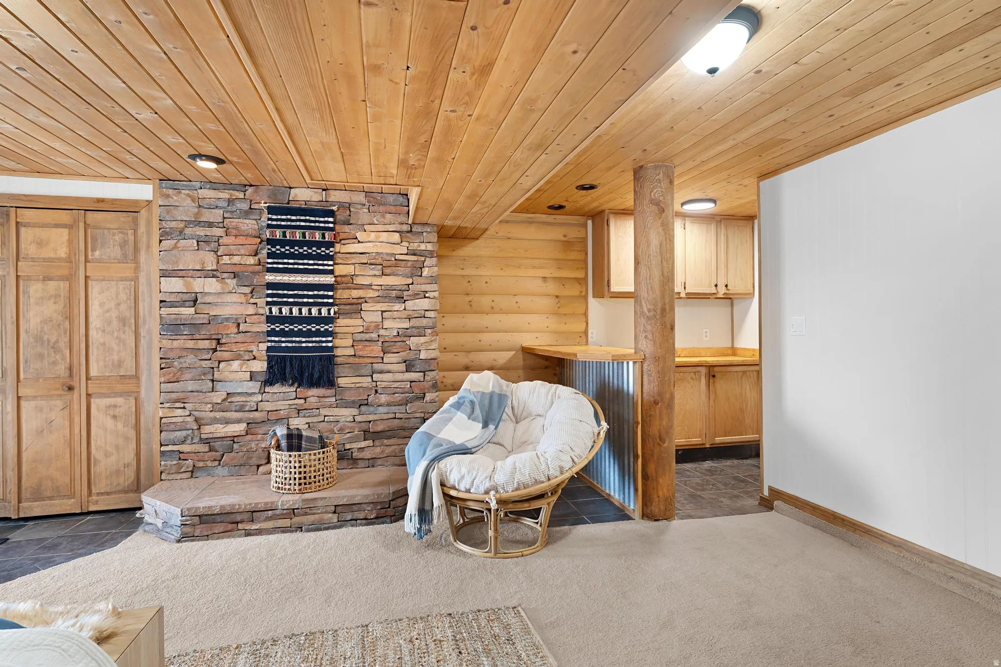 Living area featuring wood ceiling and carpet floors