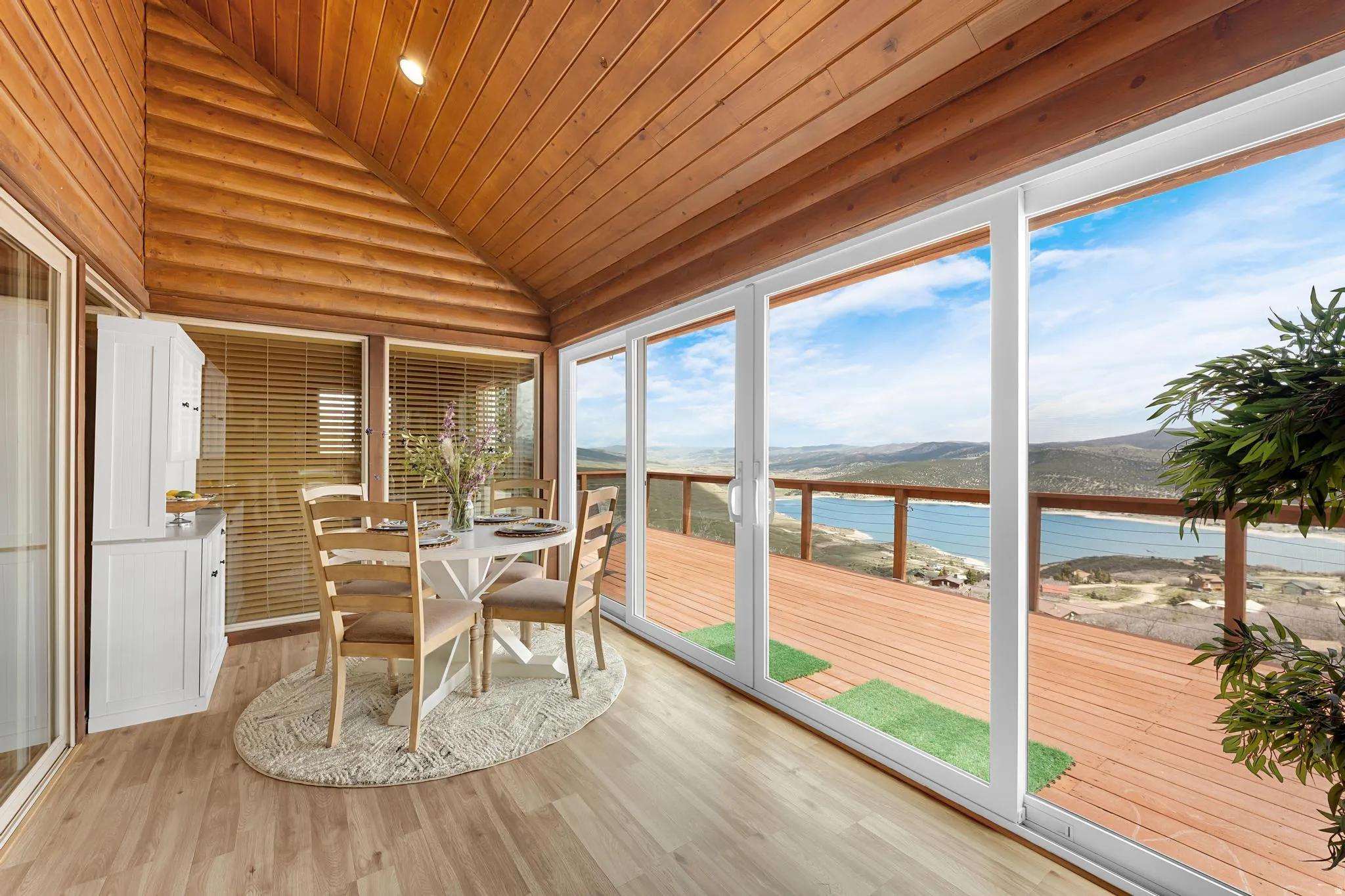 Sunroom / solarium with a water and mountain view, a vaulted wood ceiling, wood finished floors, and recessed lighting