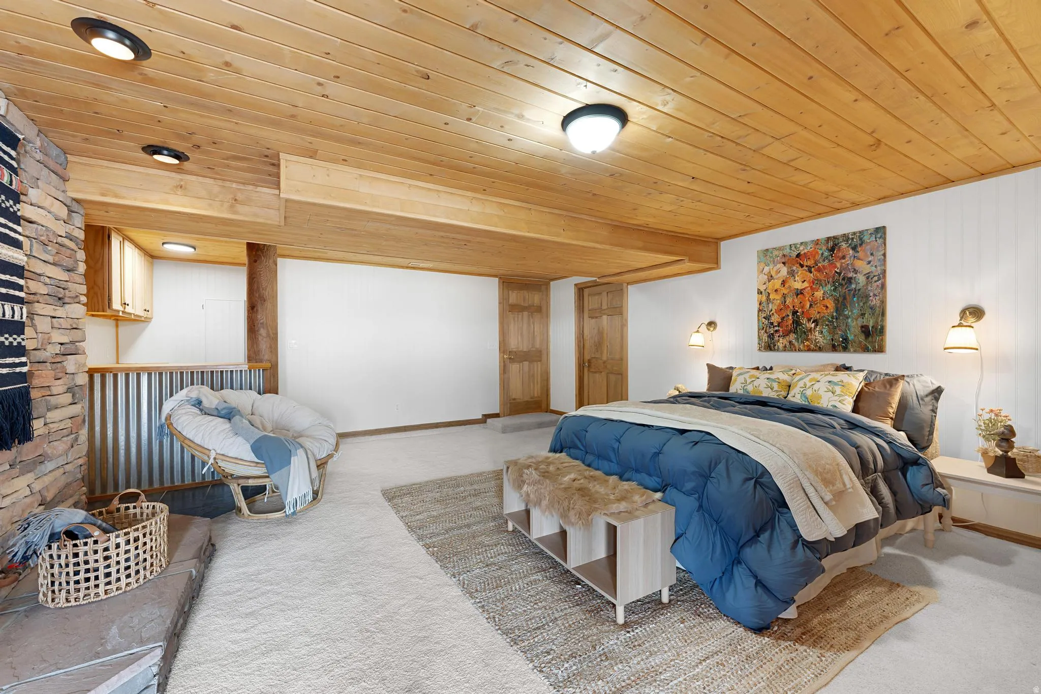 Bedroom featuring carpet, wood ceiling, and wood walls