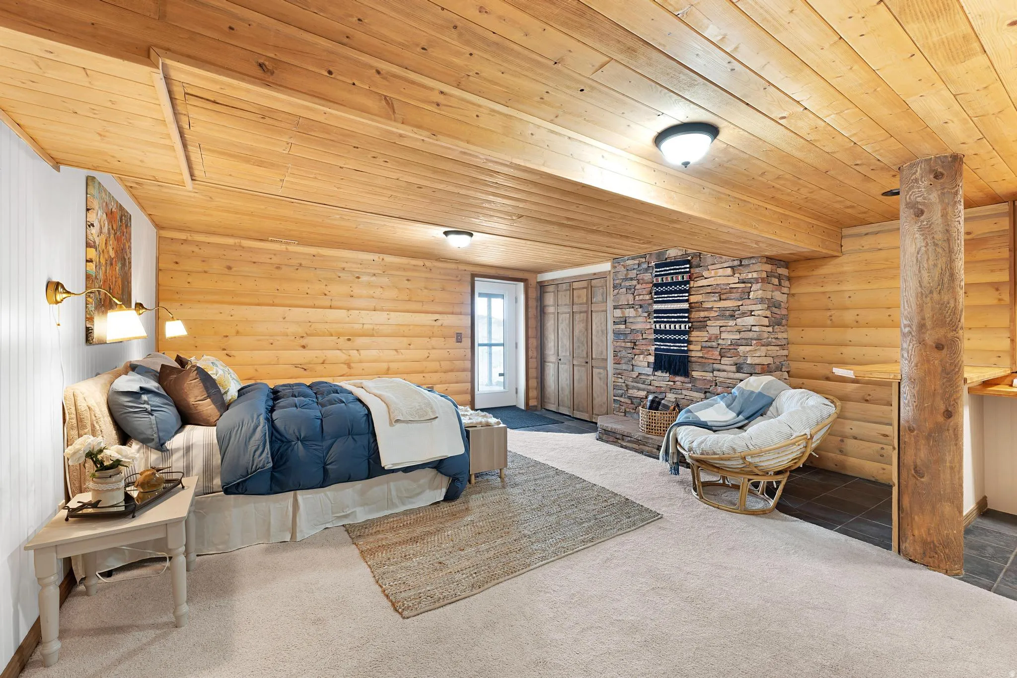 Bedroom featuring log walls, carpet, and wood ceiling