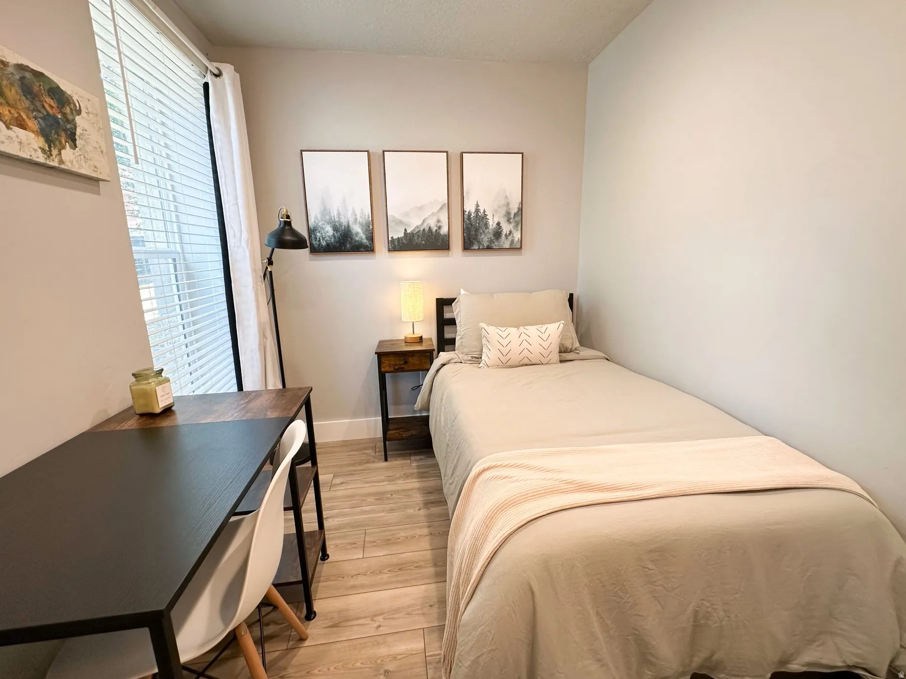 Furnished Unit #44 Bedroom featuring light wood-type flooring and baseboards