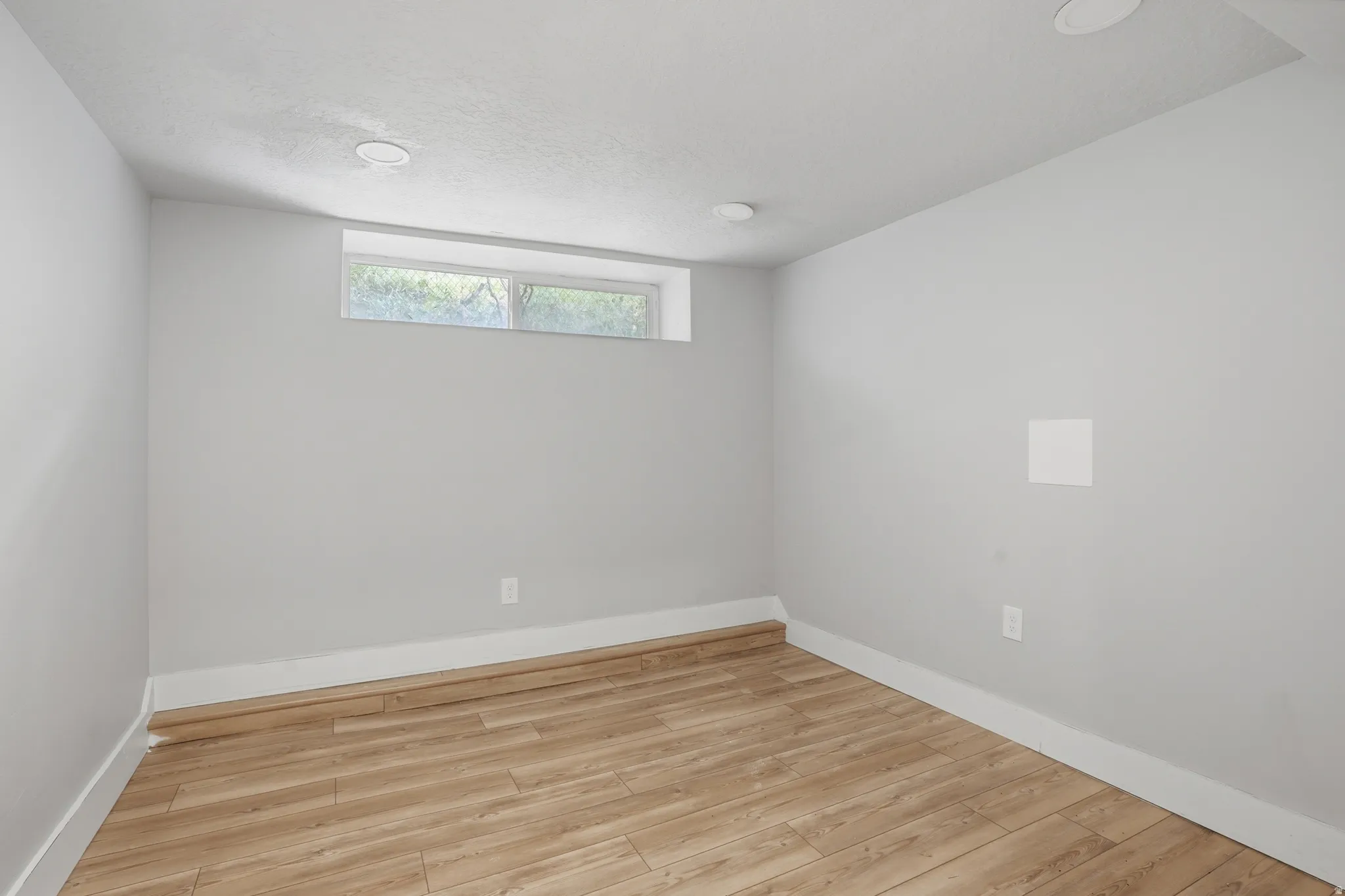 Unit #40 studio apartment with separate entrance. Spare room featuring light wood-style floors and baseboards
