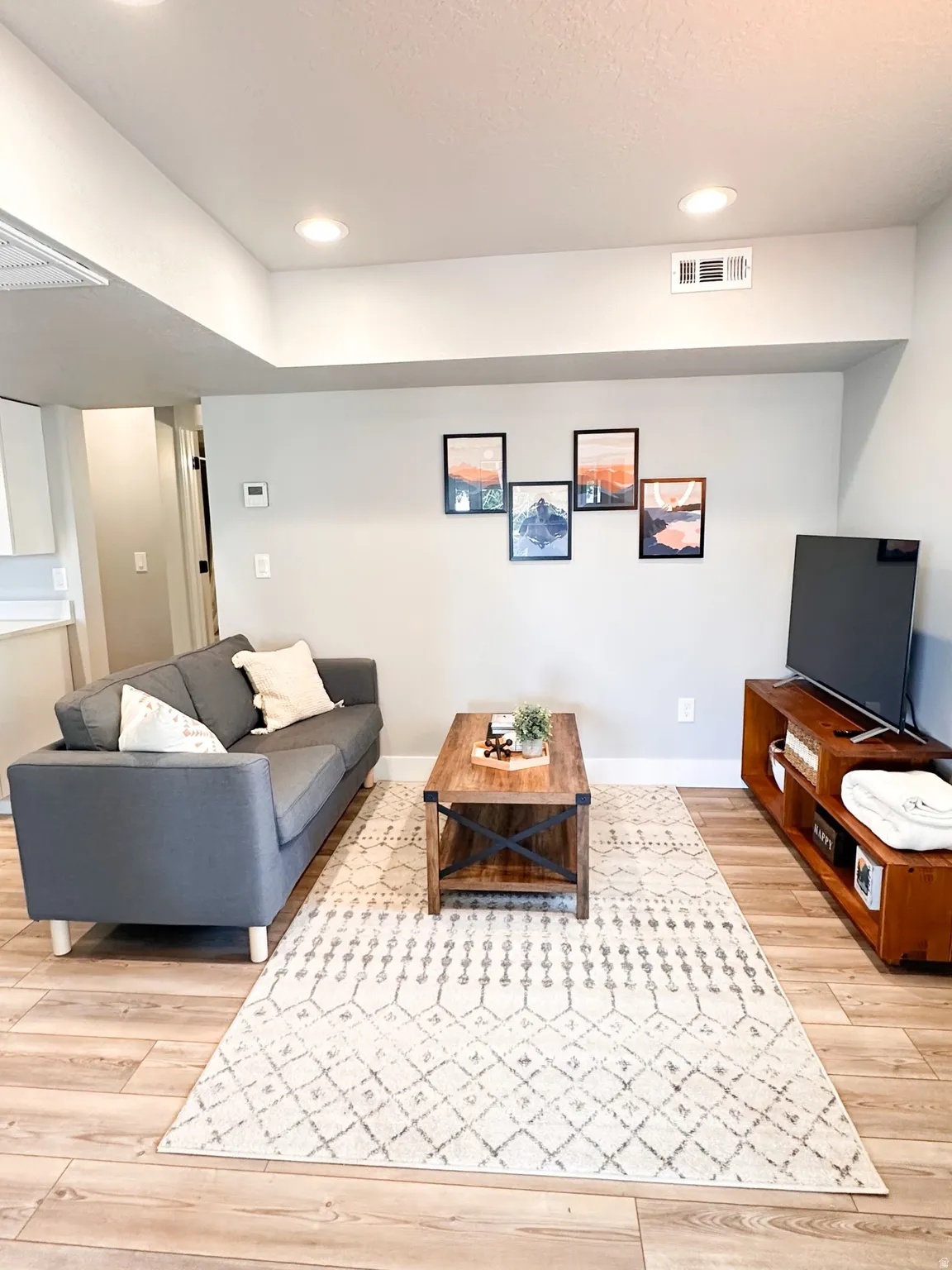 Furnished Unit #44 Living area featuring light wood finished floors and recessed lighting