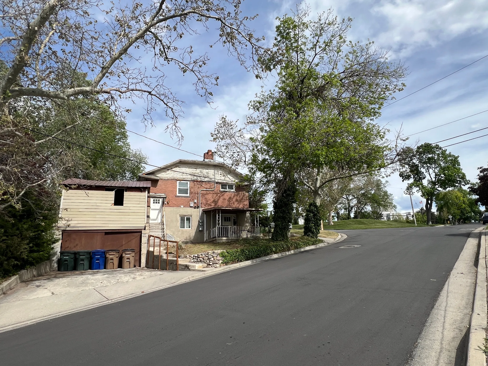 View of Capital, Garage, Driveway Parking, and Parking on asphalt road featuring curbs and sidewalks