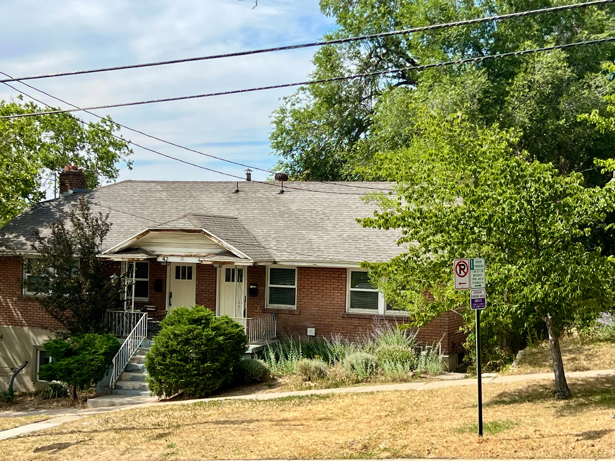 Brick exterior with a gabled roofline and chimney