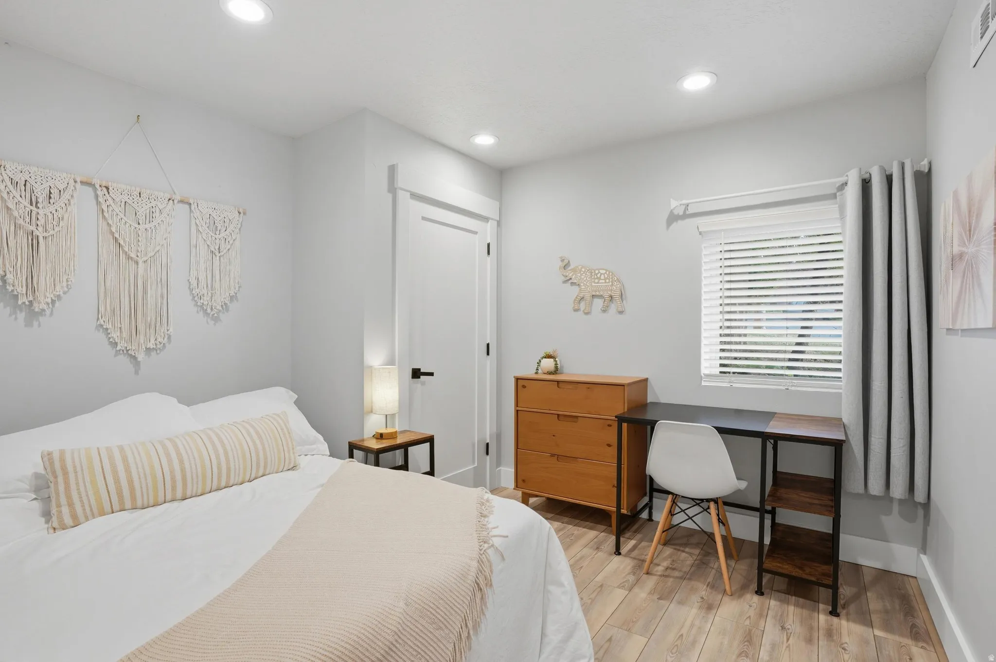 Furnished Unit #44 faces West.  Bedroom featuring recessed lighting and light wood-style floors