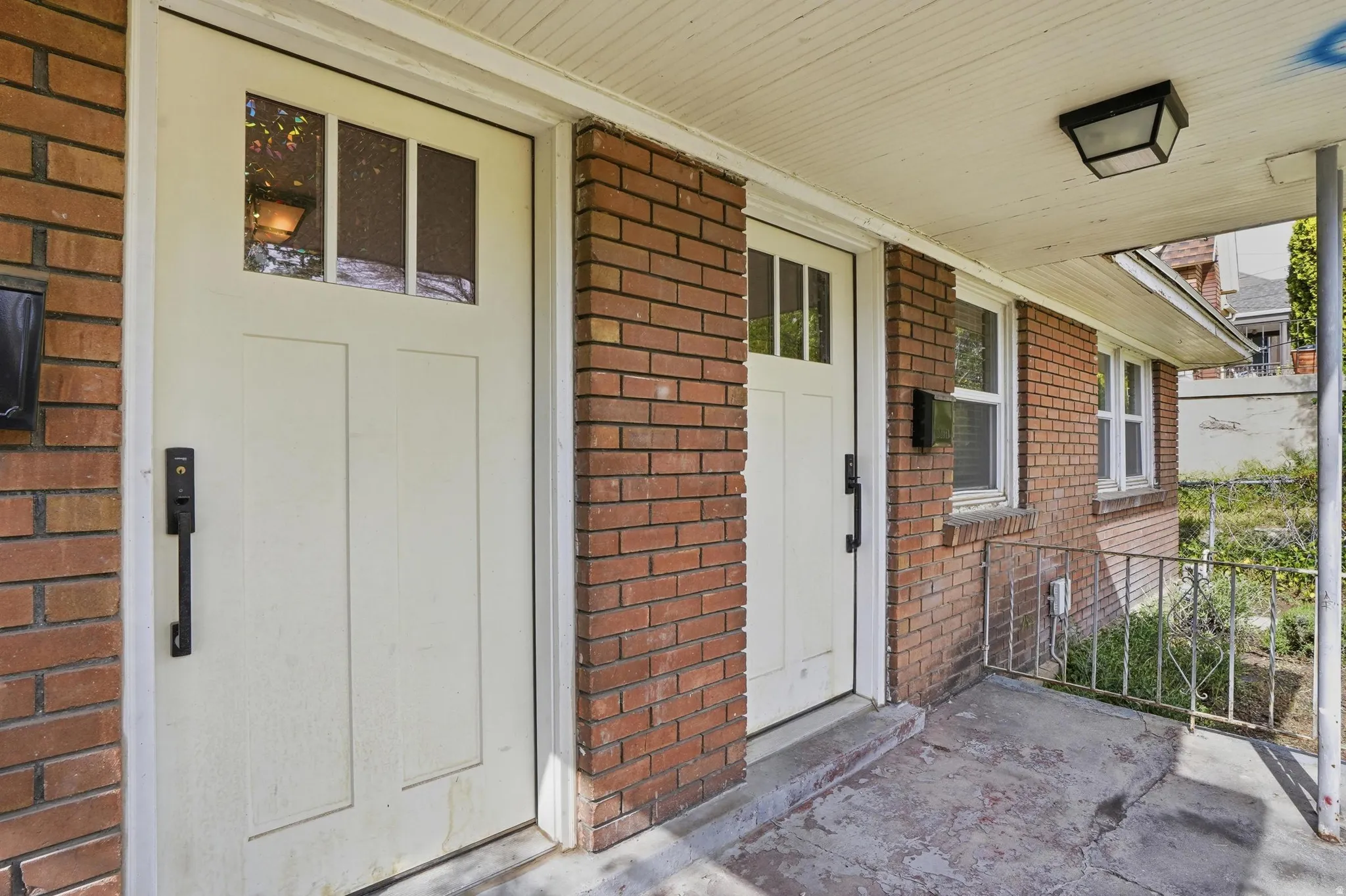 Doorways to right Unit #40 , left unit 42 featuring brick siding and covered porch