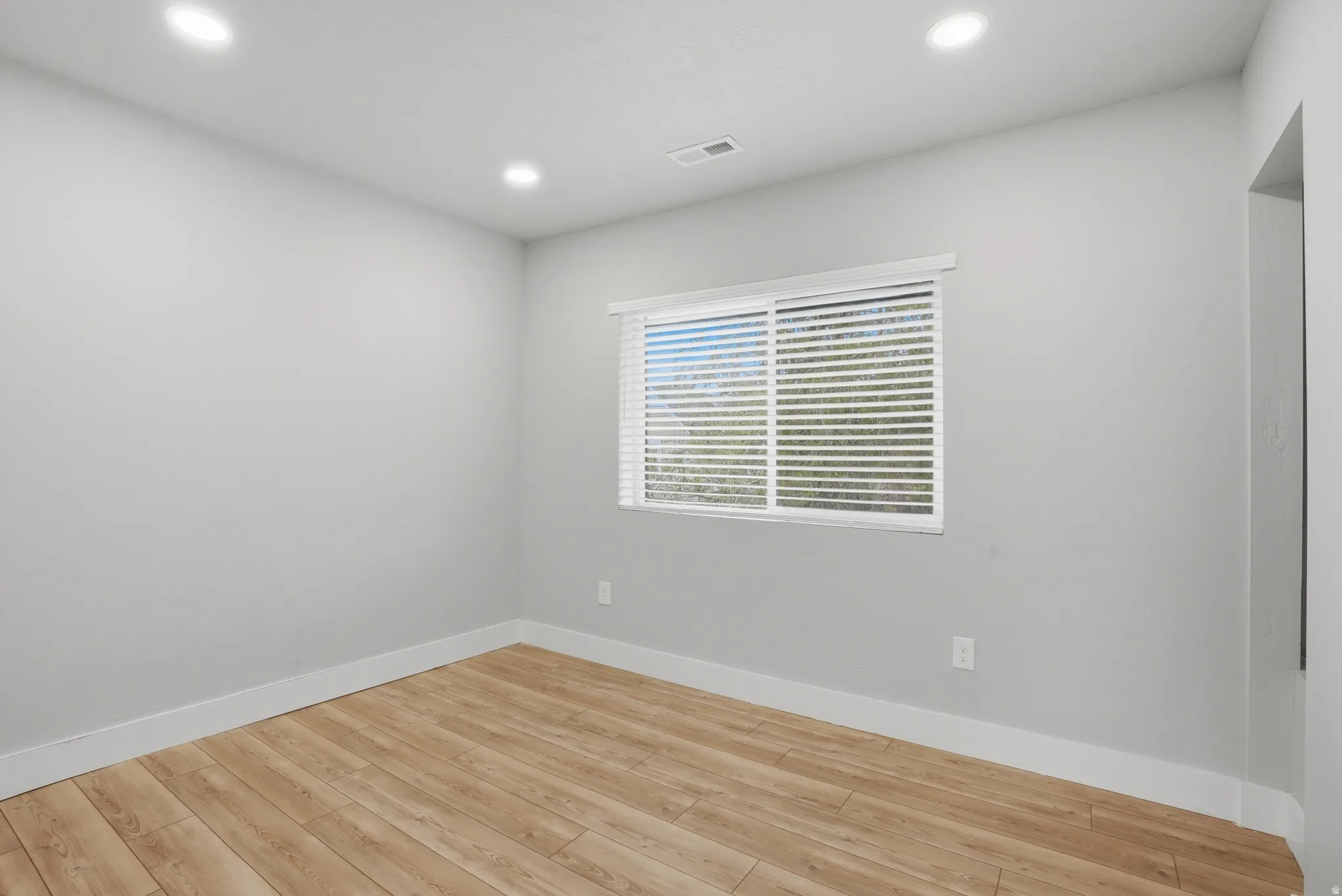 Unit #40 bedroom featuring light wood-style flooring and recessed lighting