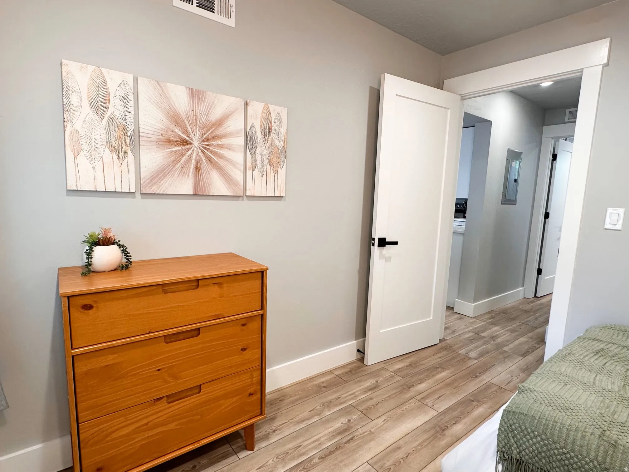 Furnished Unit #44 Bedroom featuring baseboards and light wood finished floors