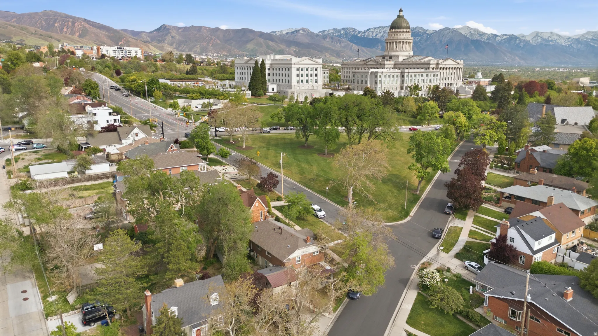 Aerial view of the exterior, street, and neighborhood with the Utah Capital Building and a mountain backdrop