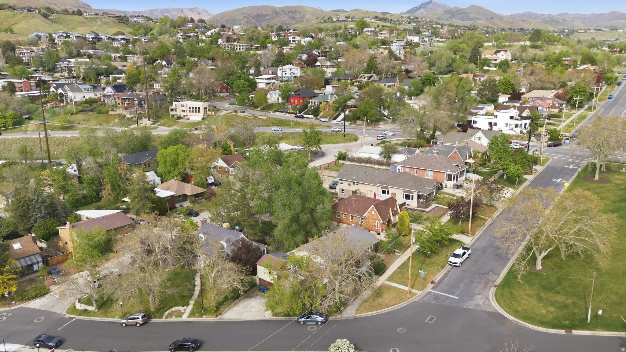Aerial view of property's location featuring nearby suburban area and a mountain backdrop