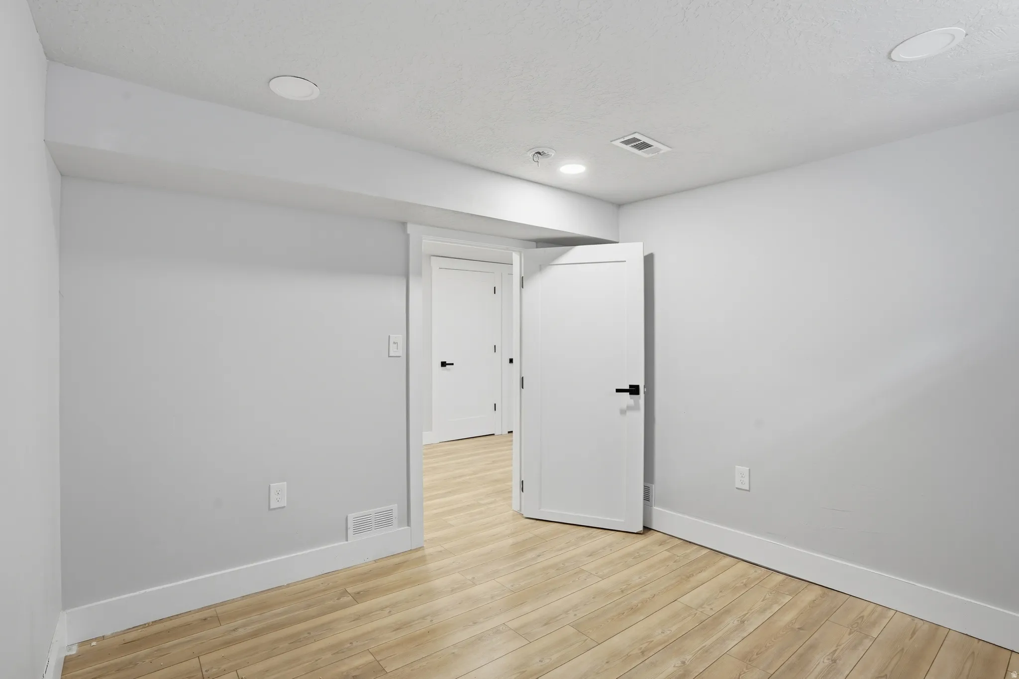 Unit #40 studio apartment with separate entrance. Unfurnished room with light wood finished floors and recessed lighting