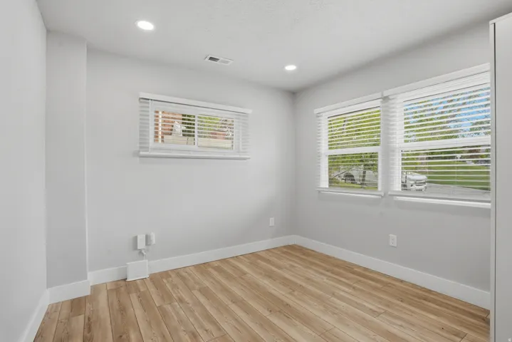 Unit #40 Empty room featuring light wood finished floors and recessed lighting